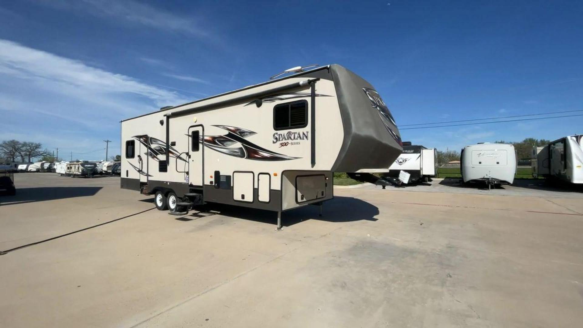 2015 WHITE SPARTAN 3210 (5ZT3STXBXFG) , located at 4319 N Main Street, Cleburne, TX, 76033, (817) 221-0660, 32.435829, -97.384178 - Here are additional factors highlighting why owning this RV is a superb choice. (1) The 2015 Spartan 3210 Toy Hauler has Aluminum-framed construction with vacuum-bonded laminated sidewalls (2) It features Electric patio awning, Pass-through storage compartments and Spare tire with lockable compa - Photo#3