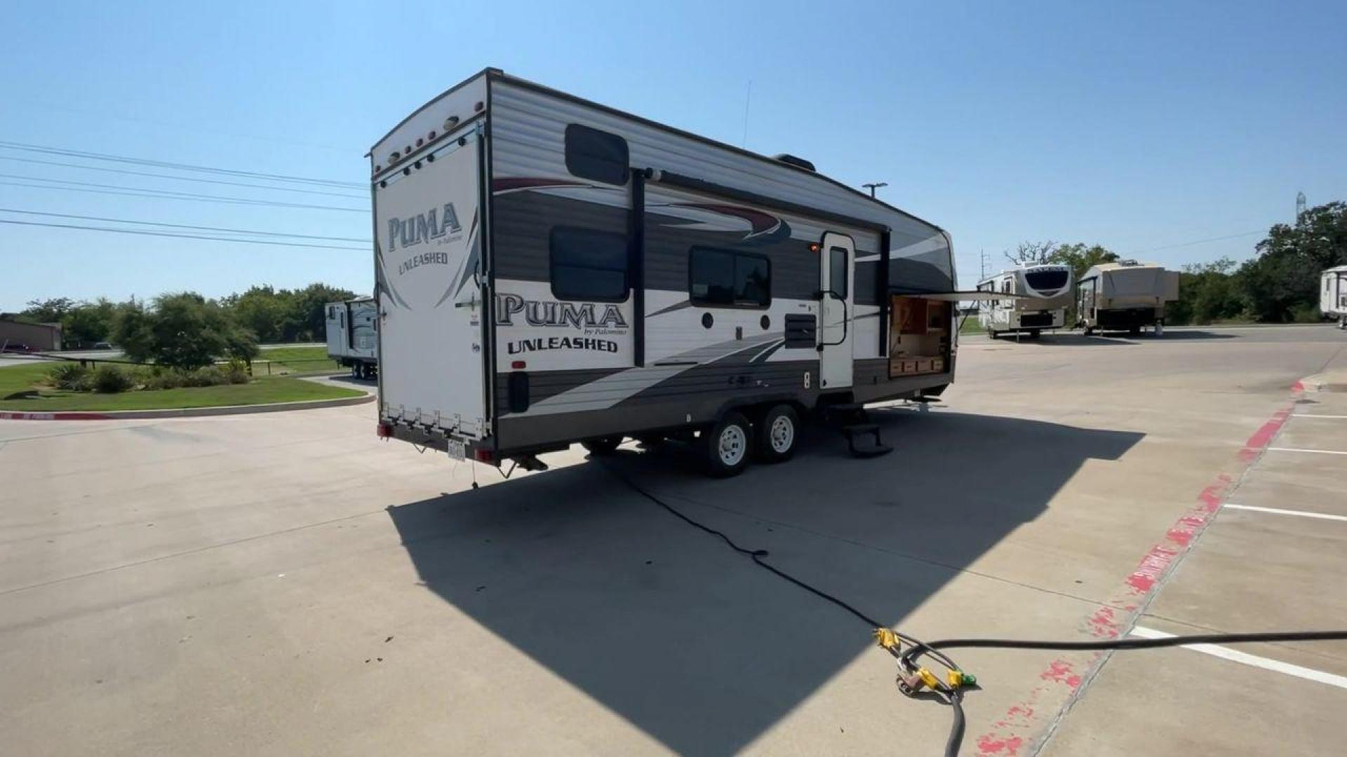 2016 FOREST RIVER PUMA UNLEASHED 25TFS (4X4TPTA27GP) , Length: 29.67 ft. | Dry Weight: 6,991 lbs. | Gross Weight: 9,939 lbs. | Slides: 0 transmission, located at 4319 N Main Street, Cleburne, TX, 76033, (817) 221-0660, 32.435829, -97.384178 - This 2016 Forest River Puma Unleashed 25TFS measures just under 30 feet long. It has a dry weight of 6,991 lbs. and a GVWR of 9,939 lbs. It comes equipped with automatic heating and cooling rated at 30,000 and 13,500 BTUs respectively. It is also designed with a 14-foot power awning. This toy hau - Photo#1