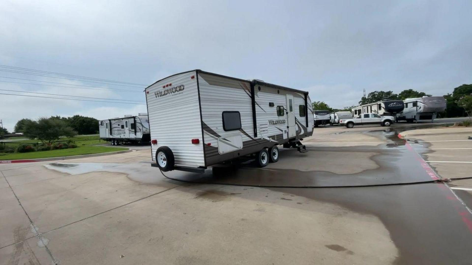 2016 WHITE FOREST RIVER WILDWOOD 28DBUD (4X4TWDD25GA) , Length: 29.83 ft. | Dry Weight: 5,847 lbs. | Slides: 1 transmission, located at 4319 N Main Street, Cleburne, TX, 76033, (817) 221-0660, 32.435829, -97.384178 - This 2016 Forest River Wildwood 28DBUD measures just a bit under 30 ft. in length. It has a dry weight of 5,847 lbs. and a payload capacity of 1,920 lbs. It is a dual-axle steel wheel set-up with 1 power-retractable slide. Inside, you will find a spacious main area with linoleum flooring. Immediatel - Photo#1