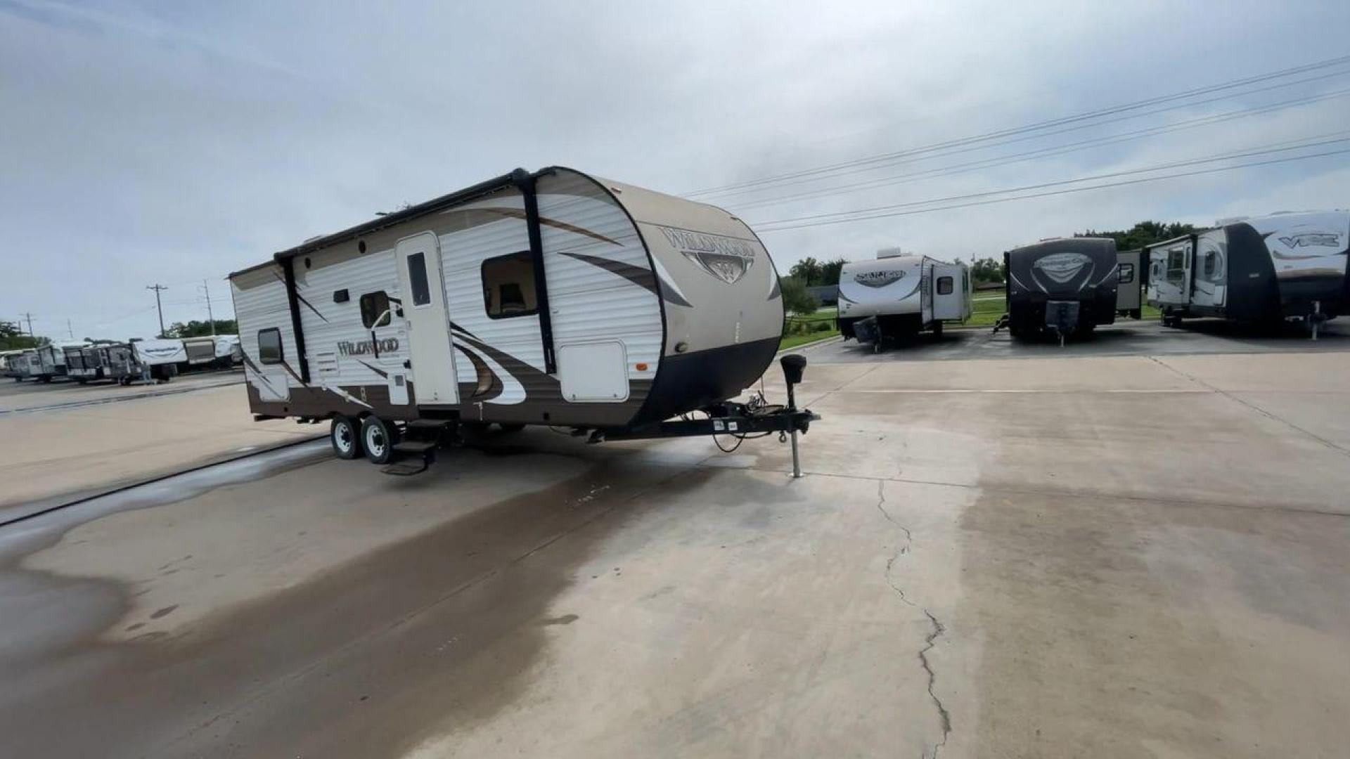 2016 WHITE FOREST RIVER WILDWOOD 28DBUD (4X4TWDD25GA) , Length: 29.83 ft. | Dry Weight: 5,847 lbs. | Slides: 1 transmission, located at 4319 N Main Street, Cleburne, TX, 76033, (817) 221-0660, 32.435829, -97.384178 - This 2016 Forest River Wildwood 28DBUD measures just a bit under 30 ft. in length. It has a dry weight of 5,847 lbs. and a payload capacity of 1,920 lbs. It is a dual-axle steel wheel set-up with 1 power-retractable slide and a 16-foot power-retractable awning. Inside, you will find a spacious m - Photo#3