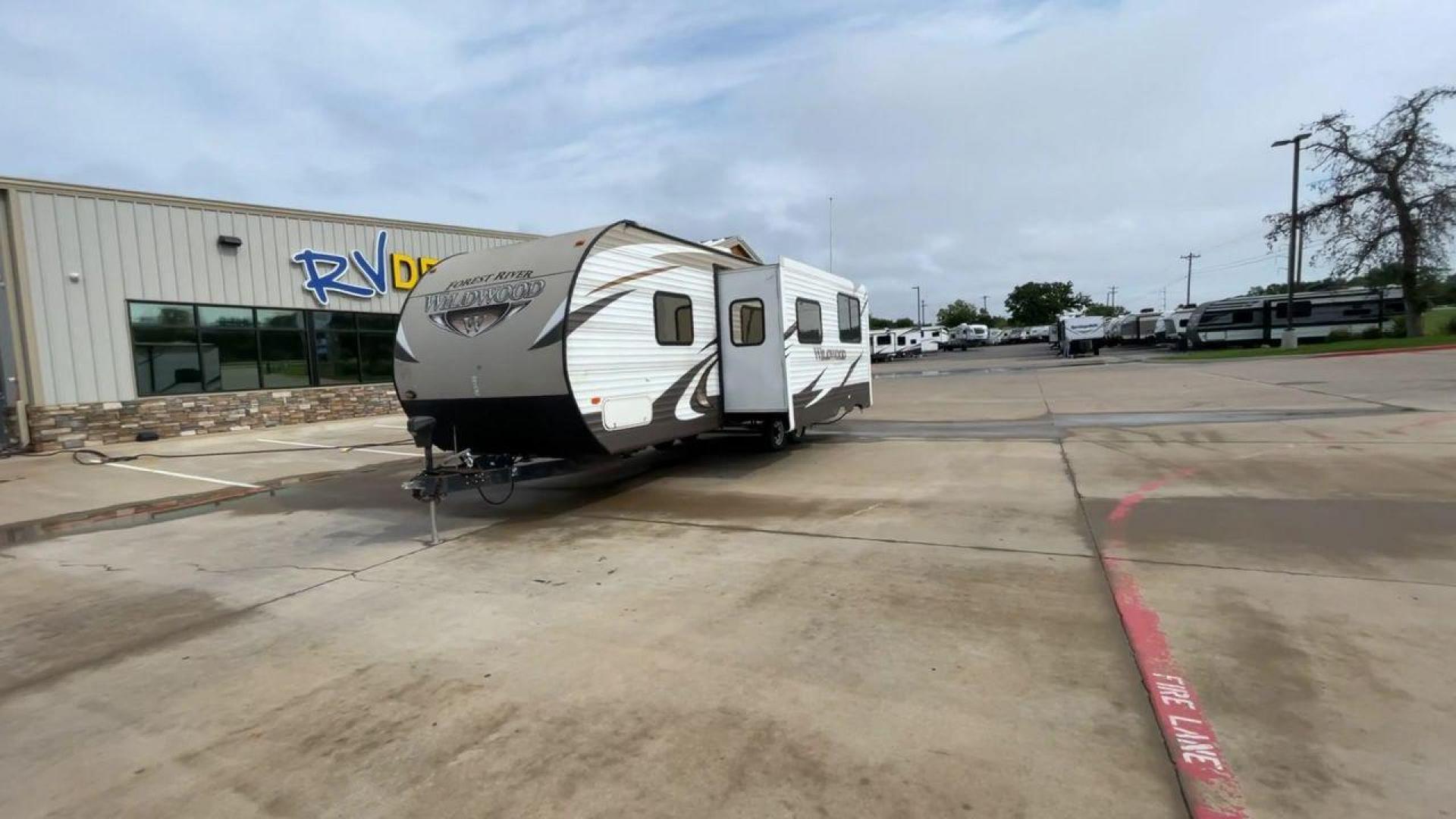 2016 WHITE FOREST RIVER WILDWOOD 28DBUD (4X4TWDD25GA) , Length: 29.83 ft. | Dry Weight: 5,847 lbs. | Slides: 1 transmission, located at 4319 N Main Street, Cleburne, TX, 76033, (817) 221-0660, 32.435829, -97.384178 - This 2016 Forest River Wildwood 28DBUD measures just a bit under 30 ft. in length. It has a dry weight of 5,847 lbs. and a payload capacity of 1,920 lbs. It is a dual-axle steel wheel set-up with 1 power-retractable slide. Inside, you will find a spacious main area with linoleum flooring. Immediatel - Photo#5