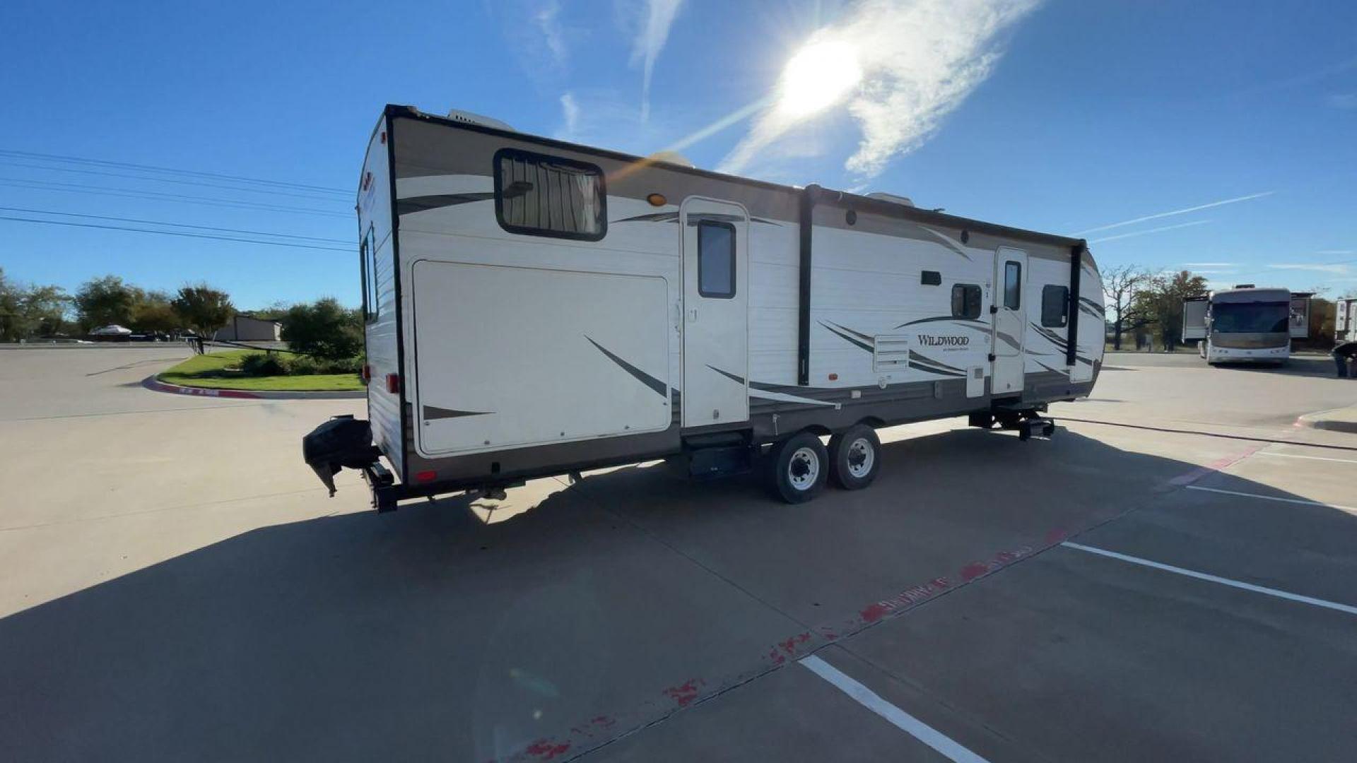 2016 FOREST RIVER WILDWOOD 32BHDS (4X4TWDH24GA) , Length: 35.67 ft. | Dry Weight: 7,955 lbs. | Slides: 2 transmission, located at 4319 N Main Street, Cleburne, TX, 76033, (817) 221-0660, 32.435829, -97.384178 - Reasons to buy this RV include: (1) It has two slide-out sections that offer more room to move around, relax, and dine comfortably compared to a non-slide trailer. (2) It offers convenient dual entry doors that create separate entry points for different areas of the RV. (3) It features a bunkhou - Photo#1