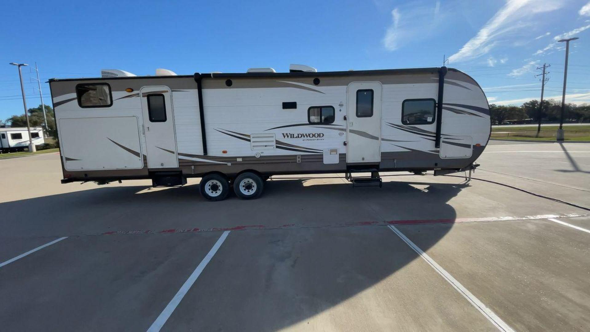 2016 FOREST RIVER WILDWOOD 32BHDS (4X4TWDH24GA) , Length: 35.67 ft. | Dry Weight: 7,955 lbs. | Slides: 2 transmission, located at 4319 N Main Street, Cleburne, TX, 76033, (817) 221-0660, 32.435829, -97.384178 - Reasons to buy this RV include: (1) It has two slide-out sections that offer more room to move around, relax, and dine comfortably compared to a non-slide trailer. (2) It offers convenient dual entry doors that create separate entry points for different areas of the RV. (3) It features a bunkhou - Photo#2