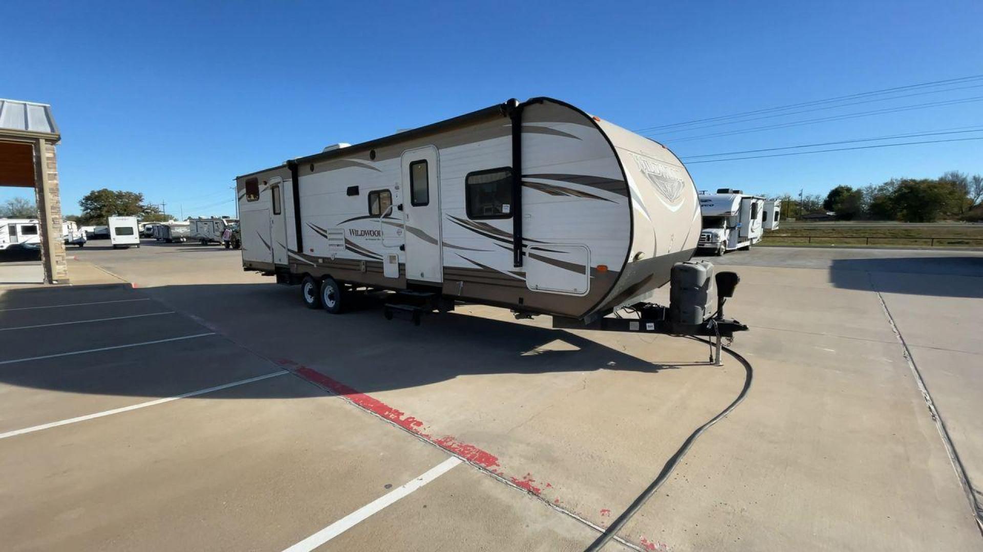 2016 FOREST RIVER WILDWOOD 32BHDS (4X4TWDH24GA) , Length: 35.67 ft. | Dry Weight: 7,955 lbs. | Slides: 2 transmission, located at 4319 N Main Street, Cleburne, TX, 76033, (817) 221-0660, 32.435829, -97.384178 - Reasons to buy this RV include: (1) It has two slide-out sections that offer more room to move around, relax, and dine comfortably compared to a non-slide trailer. (2) It offers convenient dual entry doors that create separate entry points for different areas of the RV. (3) It features a bunkhou - Photo#3