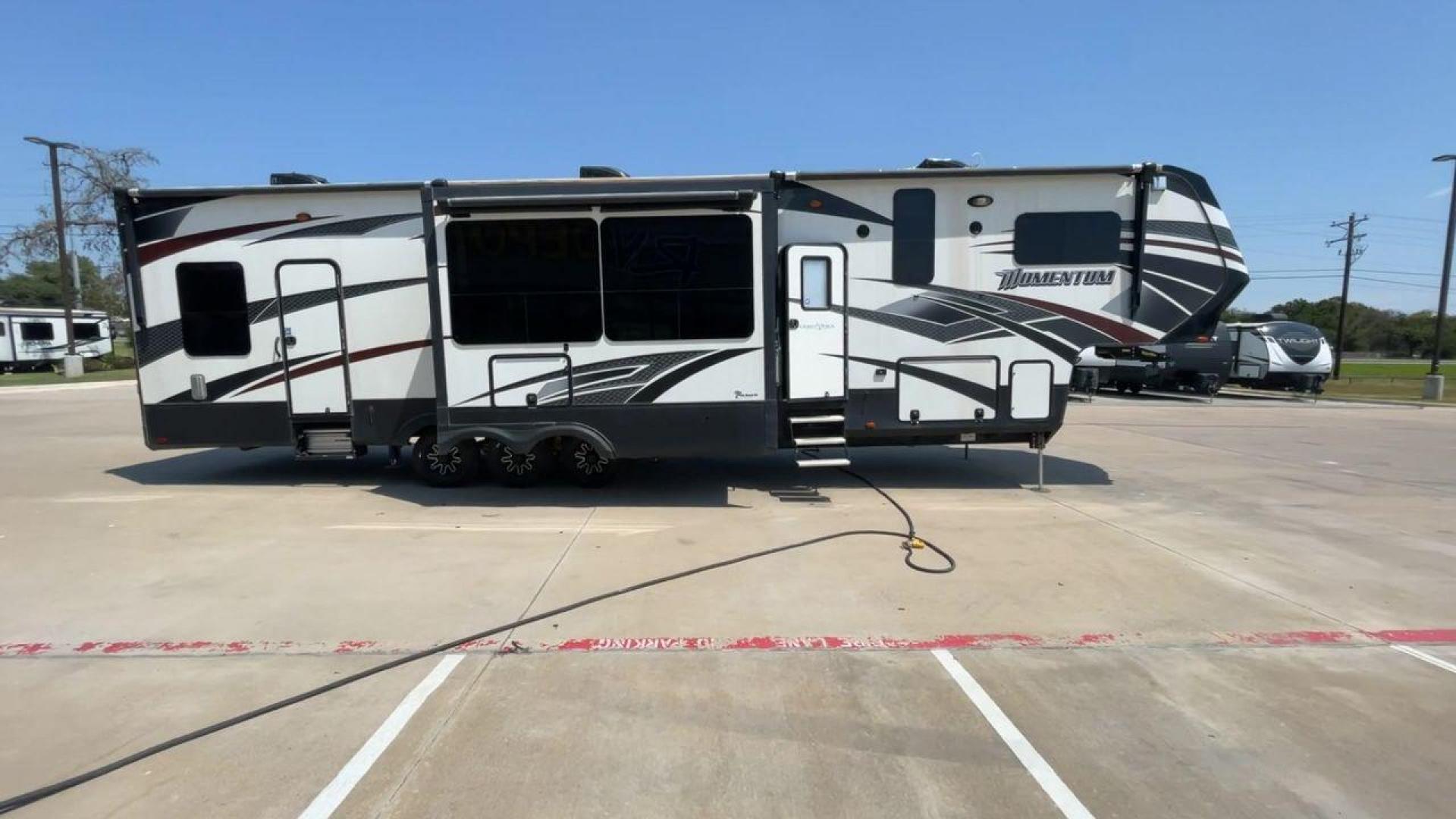 2016 GRAND DESIGN MOMENTUM 397TH (573FM4530G1) , Length: 43.25 ft. | Dry Weight: 15,500 lbs. | Gross Weight: 19,500 lbs. | Slides: 3 transmission, located at 4319 N Main Street, Cleburne, TX, 76033, (817) 221-0660, 32.435829, -97.384178 - Photo#2