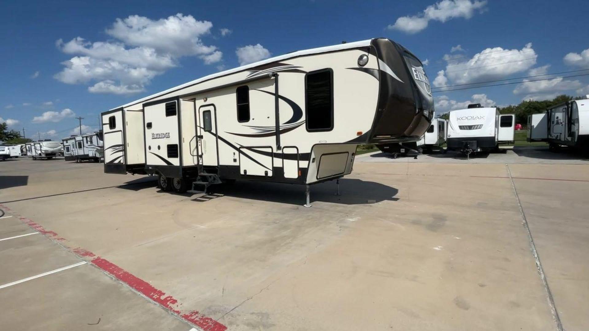 2016 TAN HEARTLAND ELKRIDGE 38RSRT (5SFRG4225GE) , Length: 41.58 ft. | Dry Weight: 13,400 lbs. | Gross Weight: 15,500 lbs. | Slides: 5 transmission, located at 4319 N Main Street, Cleburne, TX, 76033, (817) 221-0660, 32.435829, -97.384178 - This 2016 Heartland Elkridge 38RSRT is a dual-axle aluminum wheel setup measuring 41.58 ft. in length and 12.92 ft. in height. It has a dry weight of 13,400 lbs. and a GVWR of 15,500 lbs. It includes five spacious slides and one 21-foot awning. This fifth wheel highlights two bedrooms, two bathrooms - Photo#3