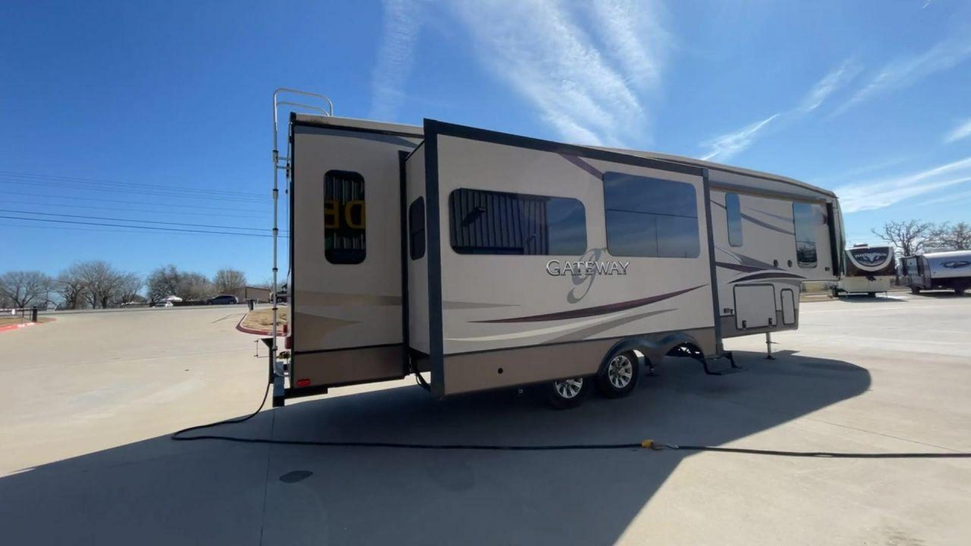 2016 HEARTLAND GATEWAY 3400SE (5SFSG3728GE) , Length: 36.7 ft. | Dry Weight: 11,724 lbs. | Gross Weight: 14,000 lbs. | Slides: 3 transmission, located at 4319 N Main Street, Cleburne, TX, 76033, (817) 221-0660, 32.435829, -97.384178 - Presenting the 2016 Heartland Gateway 3400SE—a travel trailer that sets a new standard for comfortable and stylish camping. With its ideal length, this model offers a comfortable getaway for solo travelers or families. The unit boasts a rear roof access, providing a unique vantage point to admire - Photo#1