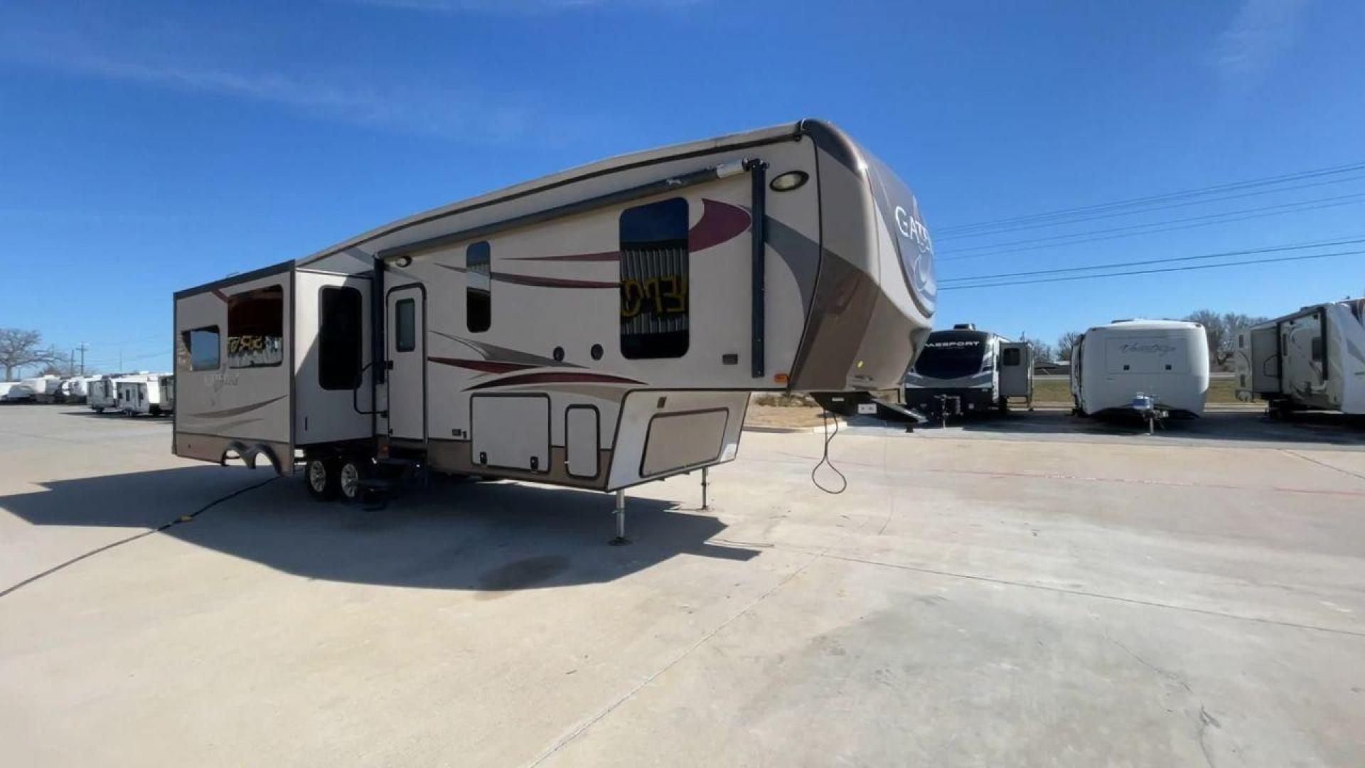 2016 HEARTLAND GATEWAY 3400SE (5SFSG3728GE) , Length: 36.7 ft. | Dry Weight: 11,724 lbs. | Gross Weight: 14,000 lbs. | Slides: 3 transmission, located at 4319 N Main Street, Cleburne, TX, 76033, (817) 221-0660, 32.435829, -97.384178 - Presenting the 2016 Heartland Gateway 3400SE—a travel trailer that sets a new standard for comfortable and stylish camping. With its ideal length, this model offers a comfortable getaway for solo travelers or families. The unit boasts a rear roof access, providing a unique vantage point to admire - Photo#3