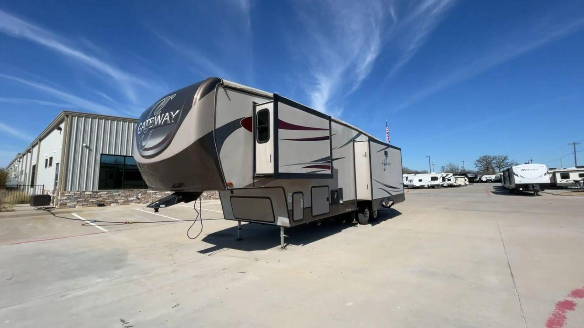 2016 HEARTLAND GATEWAY 3400SE (5SFSG3728GE) , Length: 36.7 ft. | Dry Weight: 11,724 lbs. | Gross Weight: 14,000 lbs. | Slides: 3 transmission, located at 4319 N Main Street, Cleburne, TX, 76033, (817) 221-0660, 32.435829, -97.384178 - Presenting the 2016 Heartland Gateway 3400SE—a travel trailer that sets a new standard for comfortable and stylish camping. With its ideal length, this model offers a comfortable getaway for solo travelers or families. The unit boasts a rear roof access, providing a unique vantage point to admire - Photo#5