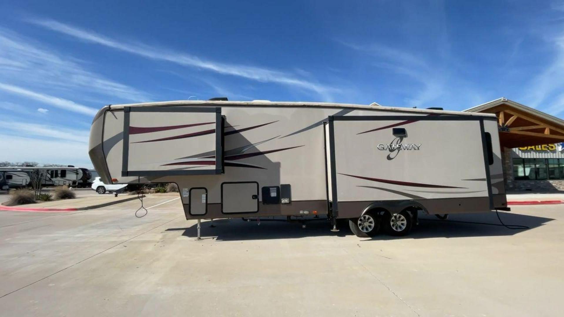 2016 HEARTLAND GATEWAY 3400SE (5SFSG3728GE) , Length: 36.7 ft. | Dry Weight: 11,724 lbs. | Gross Weight: 14,000 lbs. | Slides: 3 transmission, located at 4319 N Main Street, Cleburne, TX, 76033, (817) 221-0660, 32.435829, -97.384178 - Presenting the 2016 Heartland Gateway 3400SE—a travel trailer that sets a new standard for comfortable and stylish camping. With its ideal length, this model offers a comfortable getaway for solo travelers or families. The unit boasts a rear roof access, providing a unique vantage point to admire - Photo#6