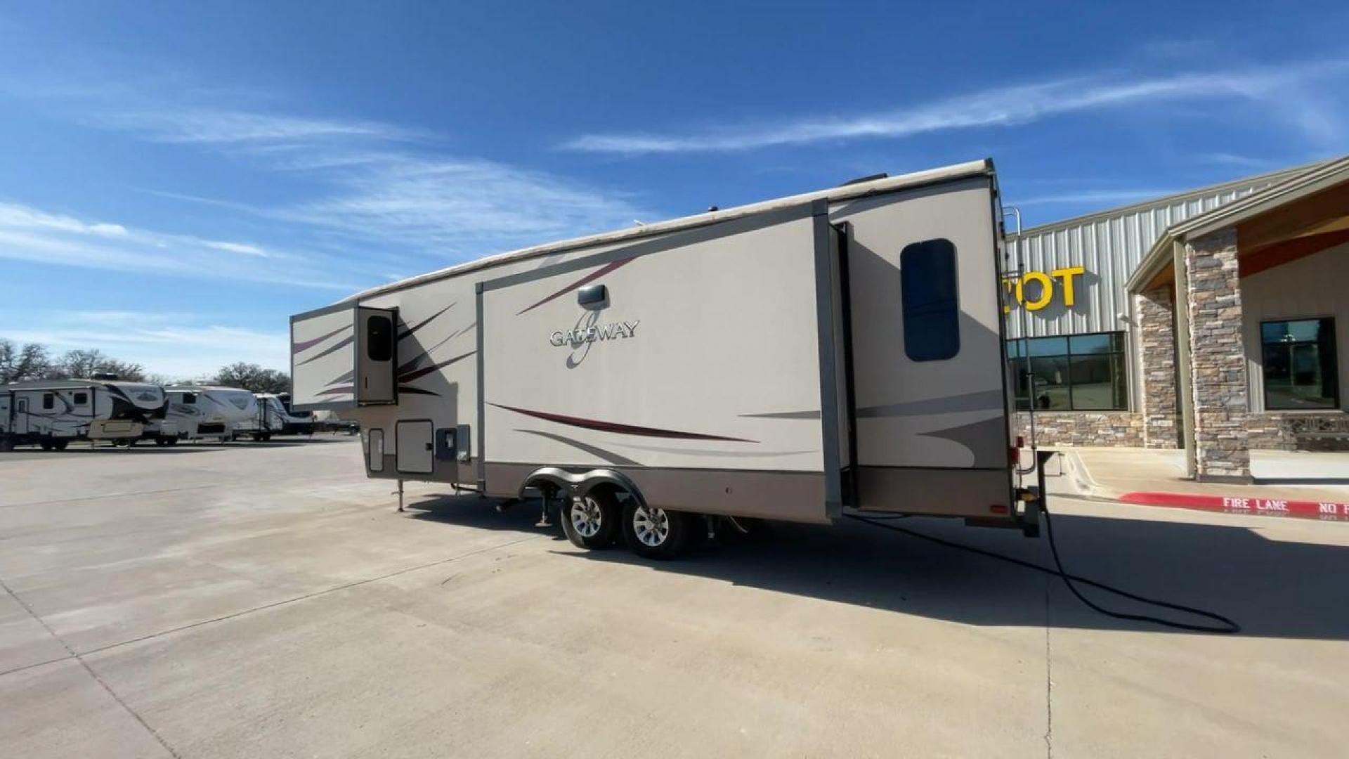 2016 HEARTLAND GATEWAY 3400SE (5SFSG3728GE) , Length: 36.7 ft. | Dry Weight: 11,724 lbs. | Gross Weight: 14,000 lbs. | Slides: 3 transmission, located at 4319 N Main Street, Cleburne, TX, 76033, (817) 221-0660, 32.435829, -97.384178 - Presenting the 2016 Heartland Gateway 3400SE—a travel trailer that sets a new standard for comfortable and stylish camping. With its ideal length, this model offers a comfortable getaway for solo travelers or families. The unit boasts a rear roof access, providing a unique vantage point to admire - Photo#7