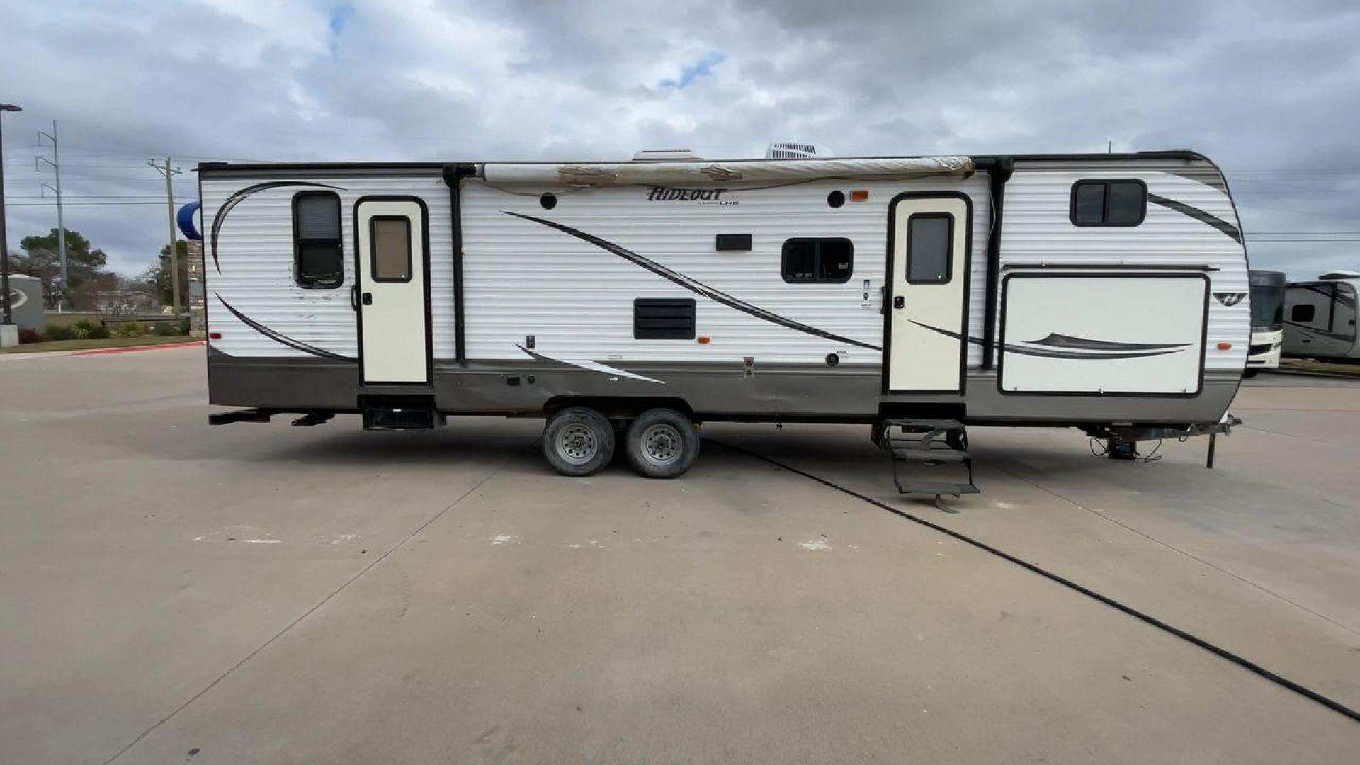 2016 WHITE HIDEOUT 300LHS - (4YDT30027G7) , Length: 35 ft | Dry Weight: 8,055 lbs | Gross Weight: 9,840 lbs. | Slides: 2 transmission, located at 4319 N Main Street, Cleburne, TX, 76033, (817) 221-0660, 32.435829, -97.384178 - The 2016 Keystone Hideout 300LHS is a well-designed travel trailer that combines comfort, functionality, and family-friendly features. Its thoughtful layout ensures a relaxing camping experience for families or groups seeking both style and practicality. The dimensions of this unit are 35 ft in leng - Photo#2