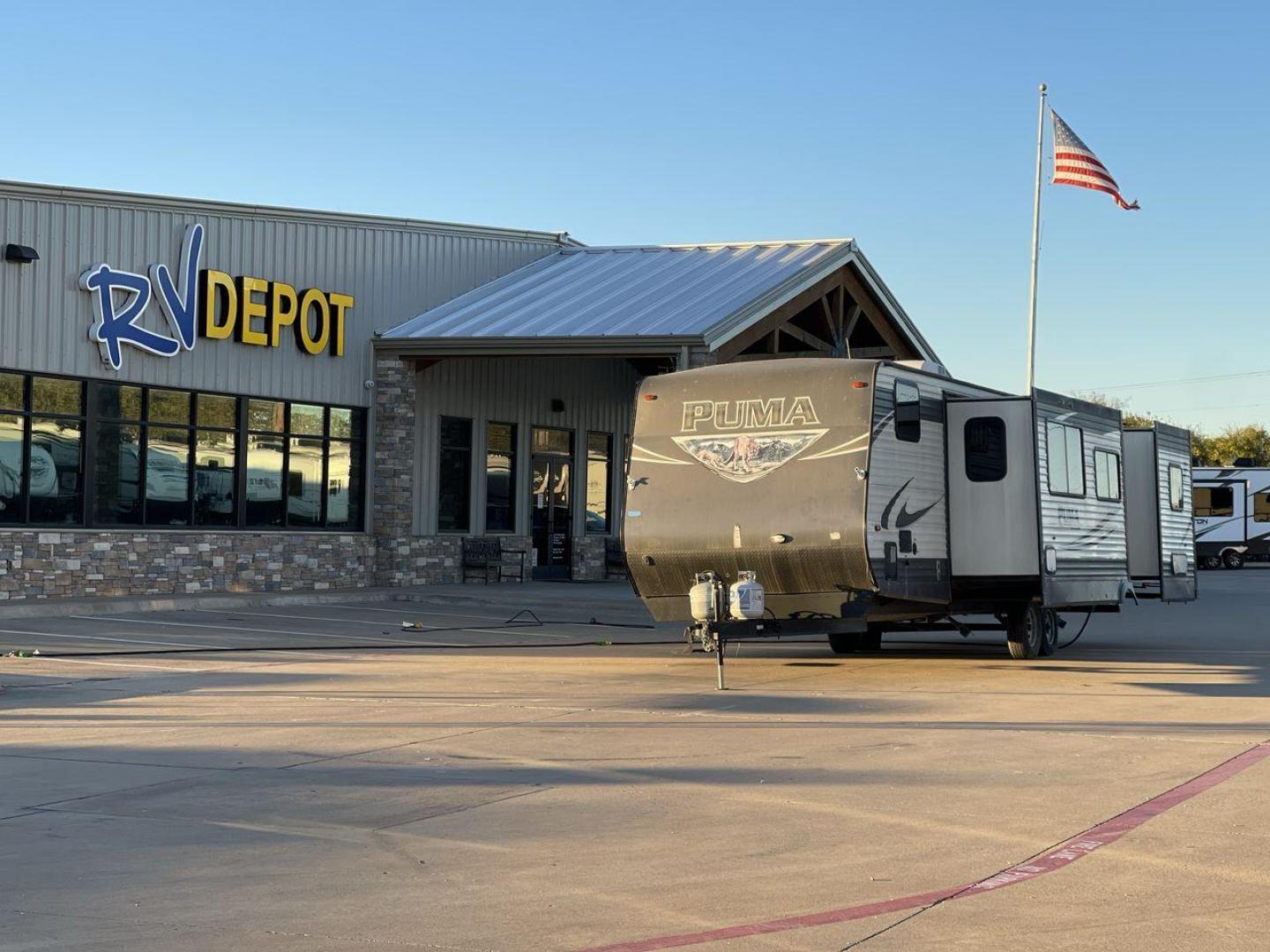 2016 TAN PUMA 32FBIS (4X4TPUH21GP) , Length: 35.33 ft. | Dry Weight: 8,858 lbs. | Gross Weight: 10,500 lbs. | Slides: 3 transmission, located at 4319 N Main Street, Cleburne, TX, 76033, (817) 221-0660, 32.435829, -97.384178 - The 2016 Puma 32FBIS travel trailer boasts a classic yet robust exterior that embodies convenience and practicality for family trips and long getaways. The travel trailer features aluminum siding in a silver tone, accentuated with subtle brown and black graphic designs that add a sleek, modern touch - Photo#0