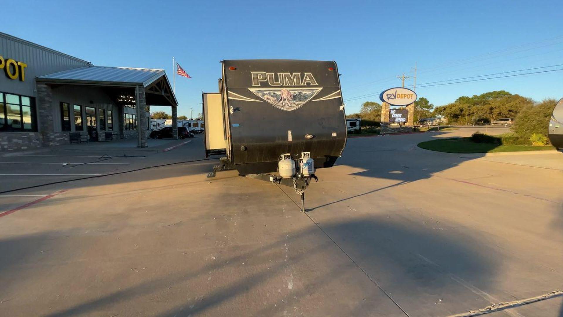 2016 TAN PUMA 32FBIS (4X4TPUH21GP) , Length: 35.33 ft. | Dry Weight: 8,858 lbs. | Gross Weight: 10,500 lbs. | Slides: 3 transmission, located at 4319 N Main Street, Cleburne, TX, 76033, (817) 221-0660, 32.435829, -97.384178 - The 2016 Puma 32FBIS travel trailer boasts a classic yet robust exterior that embodies convenience and practicality for family trips and long getaways. The travel trailer features aluminum siding in a silver tone, accentuated with subtle brown and black graphic designs that add a sleek, modern touch - Photo#4