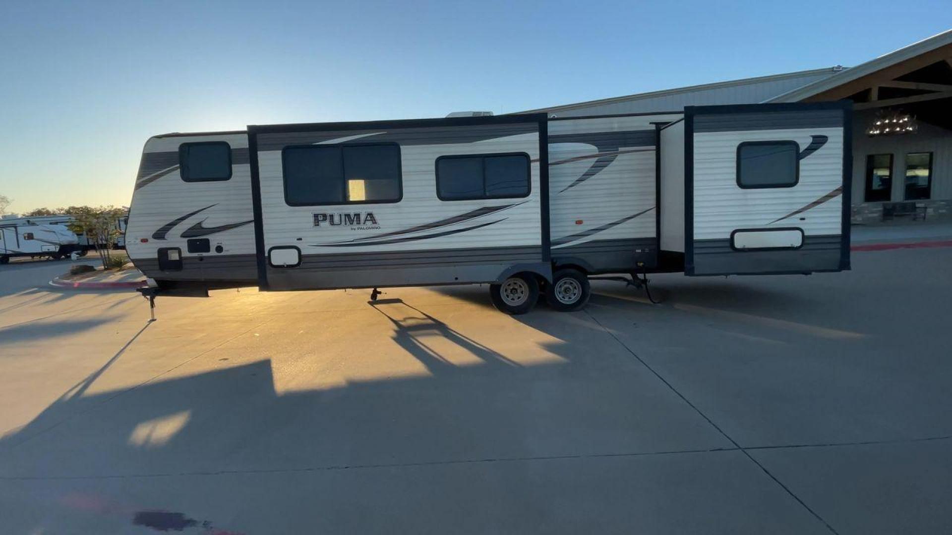 2016 TAN PUMA 32FBIS (4X4TPUH21GP) , Length: 35.33 ft. | Dry Weight: 8,858 lbs. | Gross Weight: 10,500 lbs. | Slides: 3 transmission, located at 4319 N Main Street, Cleburne, TX, 76033, (817) 221-0660, 32.435829, -97.384178 - The 2016 Puma 32FBIS travel trailer boasts a classic yet robust exterior that embodies convenience and practicality for family trips and long getaways. The travel trailer features aluminum siding in a silver tone, accentuated with subtle brown and black graphic designs that add a sleek, modern touch - Photo#6