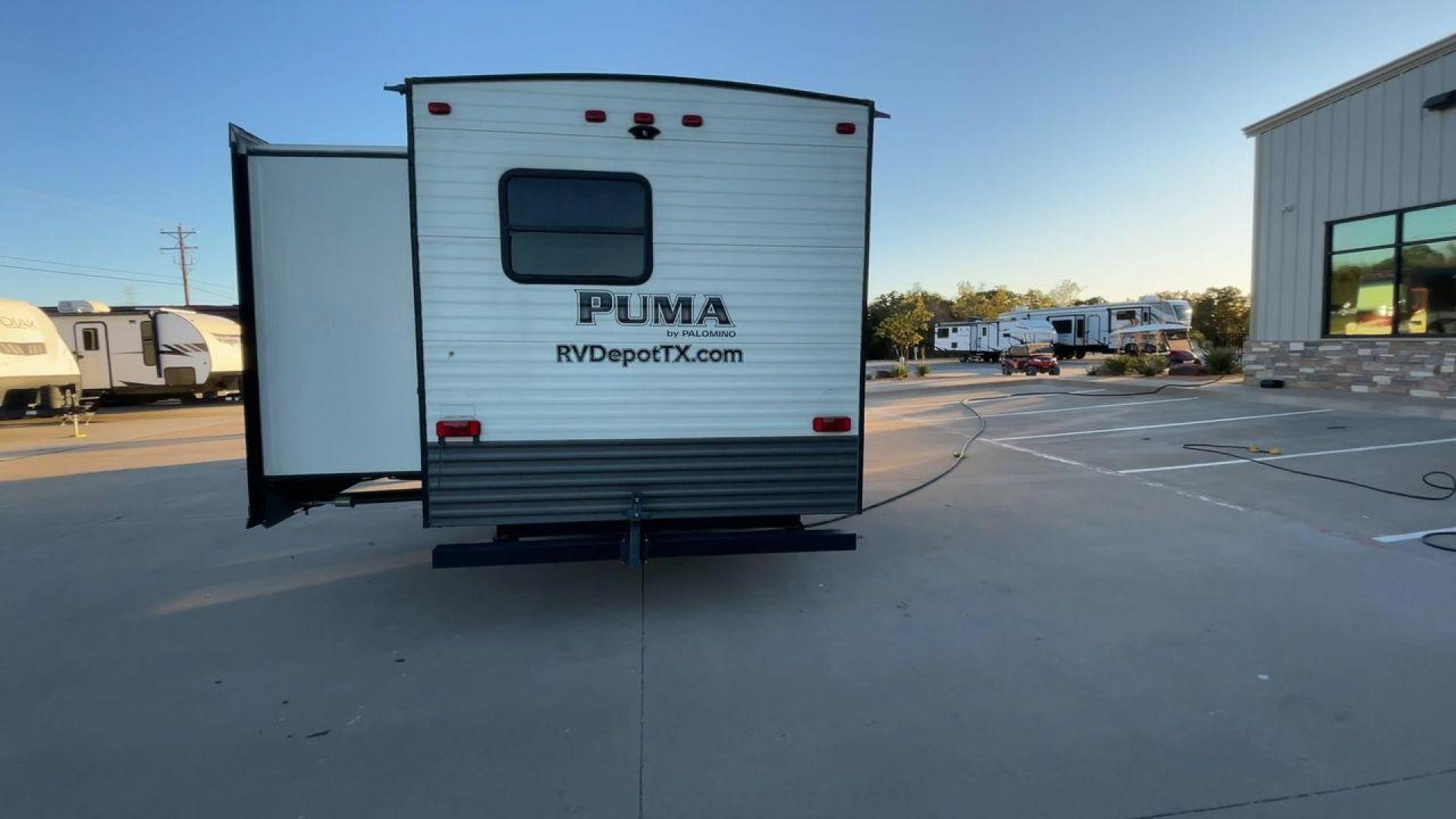 2016 TAN PUMA 32FBIS (4X4TPUH21GP) , Length: 35.33 ft. | Dry Weight: 8,858 lbs. | Gross Weight: 10,500 lbs. | Slides: 3 transmission, located at 4319 N Main Street, Cleburne, TX, 76033, (817) 221-0660, 32.435829, -97.384178 - The 2016 Puma 32FBIS travel trailer boasts a classic yet robust exterior that embodies convenience and practicality for family trips and long getaways. The travel trailer features aluminum siding in a silver tone, accentuated with subtle brown and black graphic designs that add a sleek, modern touch - Photo#8