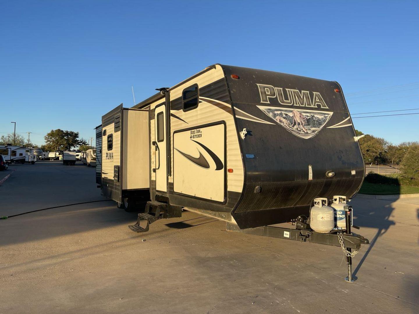 2016 TAN PUMA 32FBIS (4X4TPUH21GP) , Length: 35.33 ft. | Dry Weight: 8,858 lbs. | Gross Weight: 10,500 lbs. | Slides: 3 transmission, located at 4319 N Main Street, Cleburne, TX, 76033, (817) 221-0660, 32.435829, -97.384178 - The 2016 Puma 32FBIS travel trailer boasts a classic yet robust exterior that embodies convenience and practicality for family trips and long getaways. The travel trailer features aluminum siding in a silver tone, accentuated with subtle brown and black graphic designs that add a sleek, modern touch - Photo#21