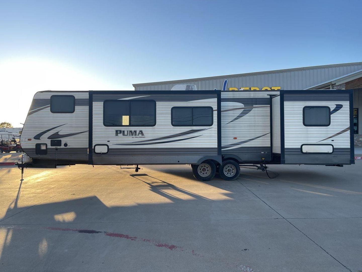 2016 TAN PUMA 32FBIS (4X4TPUH21GP) , Length: 35.33 ft. | Dry Weight: 8,858 lbs. | Gross Weight: 10,500 lbs. | Slides: 3 transmission, located at 4319 N Main Street, Cleburne, TX, 76033, (817) 221-0660, 32.435829, -97.384178 - The 2016 Puma 32FBIS travel trailer boasts a classic yet robust exterior that embodies convenience and practicality for family trips and long getaways. The travel trailer features aluminum siding in a silver tone, accentuated with subtle brown and black graphic designs that add a sleek, modern touch - Photo#22