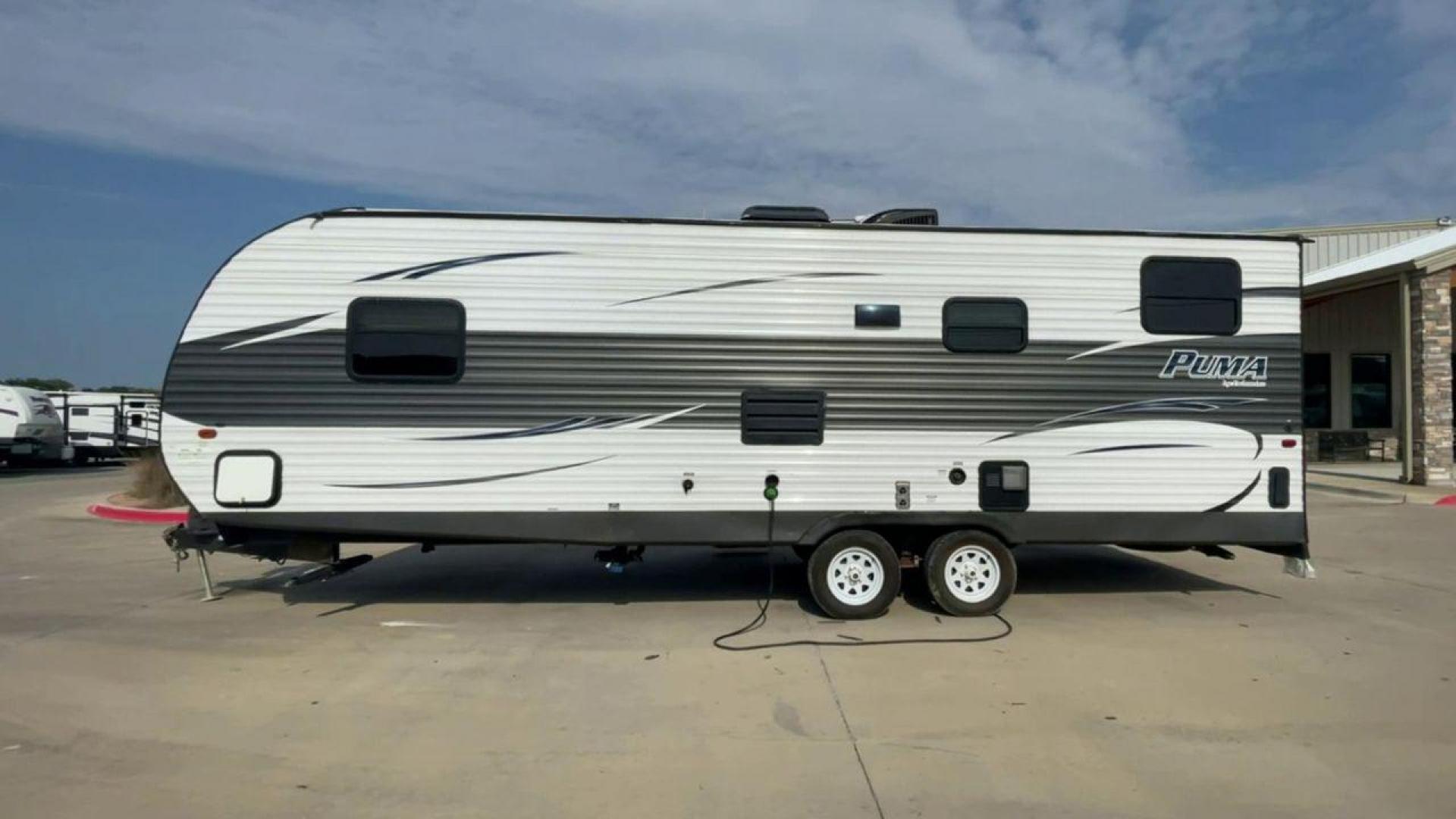 2016 GRAY PUMA XLE CANYON CAT 25FBC - (4X4TPUA2XGP) , Length: 29.58 ft.| Dry Weight: 5,390 lbs. | Gross Weight: 7,775 lbs. | Slides: 0 transmission, located at 4319 N Main Street, Cleburne, TX, 76033, (817) 221-0660, 32.435829, -97.384178 - The 2016 Puma XLE Canyon Cat 25FBC, with its 28-foot length and 8-foot width, showcases Palomino RV's commitment to providing a compact and practical travel experience. It provides a great balance between size and towing efficiency. The construction showcases a powder-coated steel I-beam frame, alum - Photo#2