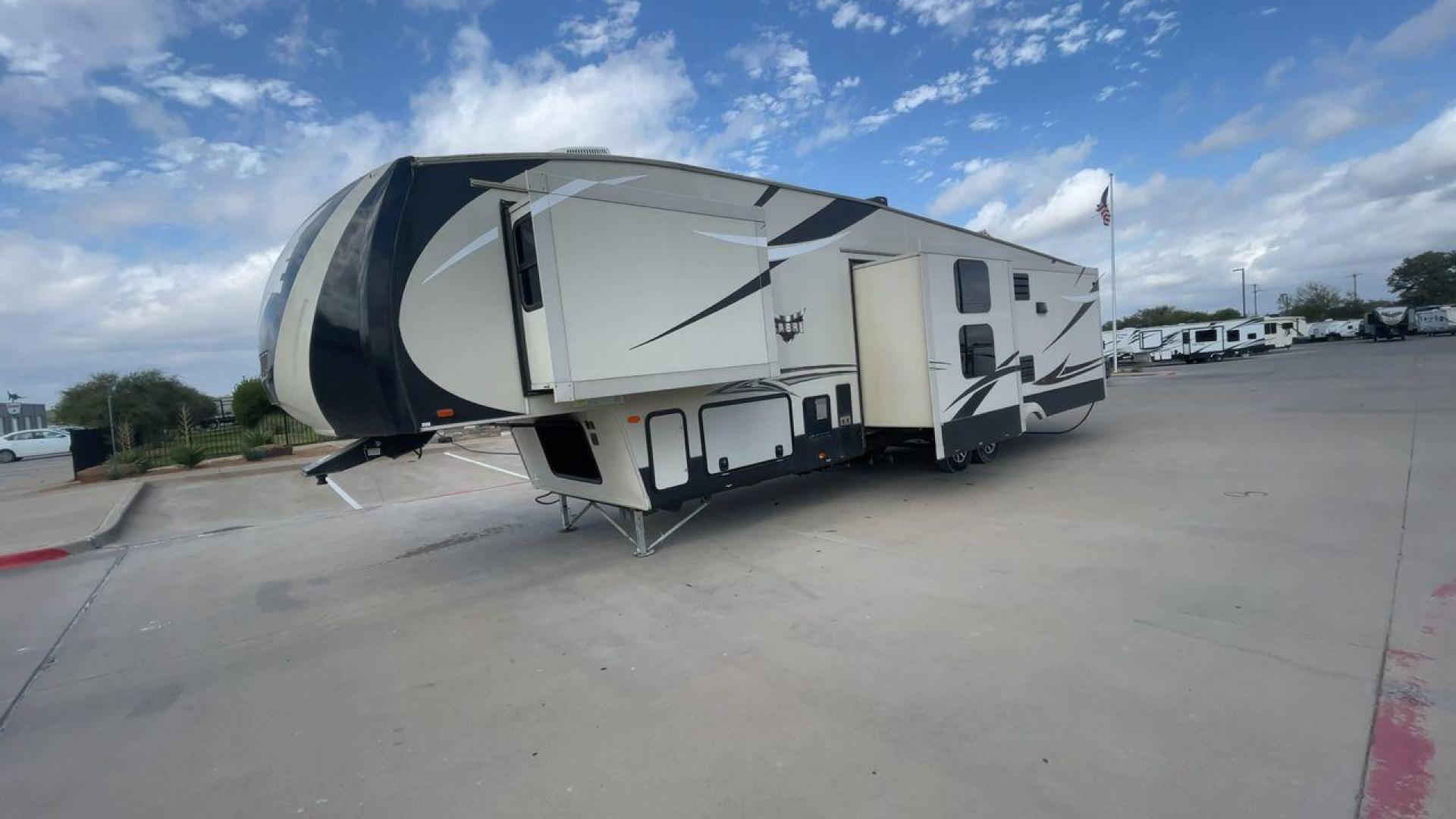 2016 TAN SABRE 365MB (4X4FSRN29G3) , Length: 42.42 ft. | Dry Weight: 12,994 lbs. | Gross Weight: 15,500 lbs. | Slides: 4 transmission, located at 4319 N Main Street, Cleburne, TX, 76033, (817) 221-0660, 32.435829, -97.384178 - The 2016 Sabre 365MB Fifth Wheel stretches 42.42 feet in length, with a commanding presence on the road and at the campground. The exterior is finished in a beige and black color scheme, accented with bold swooping graphics that add an athletic flair to its overall look. The side profile features fo - Photo#5