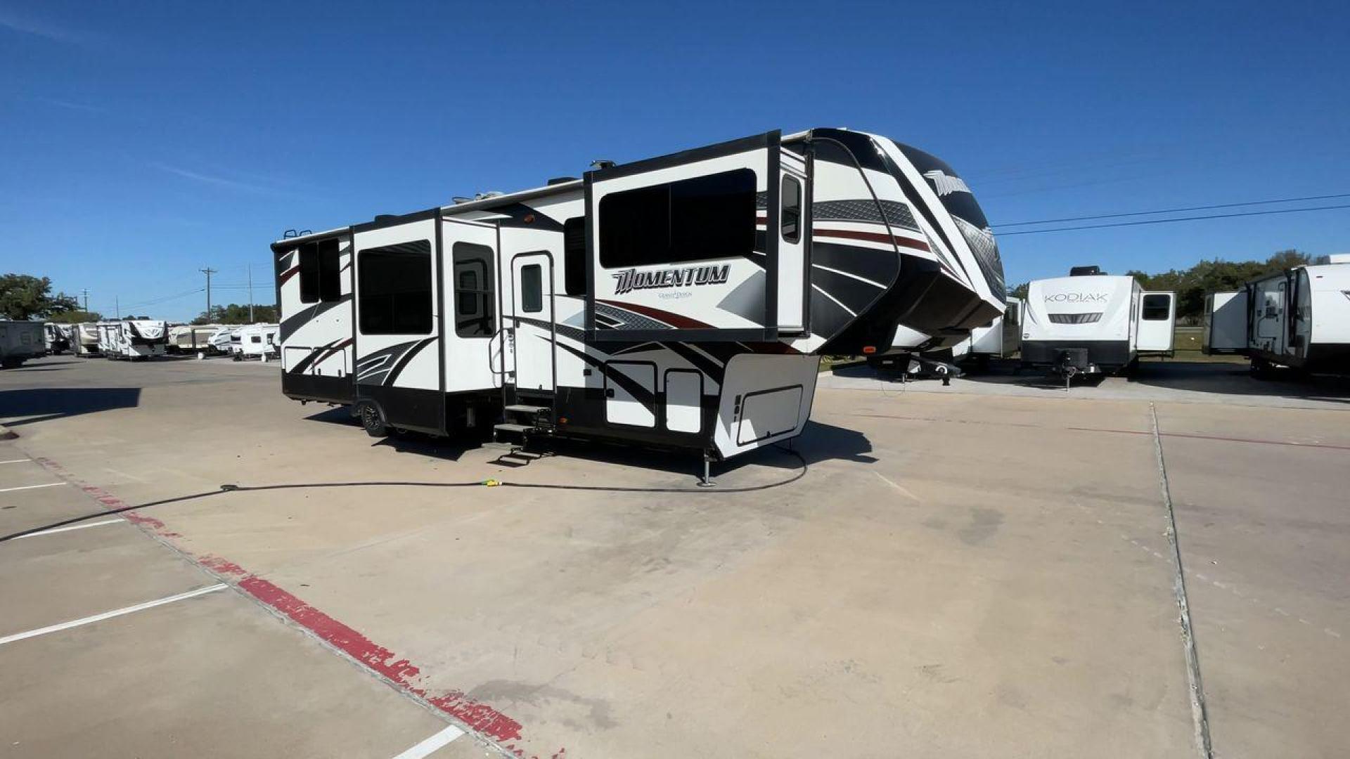 2017 GRAND DESIGN MOMENTUM 376TH (573FM4330H1) , Length: 41.25 ft. | Dry Weight: 15,900 lbs. | Gross Weight: 20,000 lbs. | Slides: 5 transmission, located at 4319 N Main Street, Cleburne, TX, 76033, (817) 221-0660, 32.435829, -97.384178 - The 2017 Grand Design Momentum 376TH is a spacious fifth wheel. It measures 41.25 feet in length and built for comfort and convenience. With a dry weight of 15,900 lbs and a gross weight capacity of 20,000 lbs, this RV is sturdy and ready for adventure. It features five slide-outs, providing ample l - Photo#3