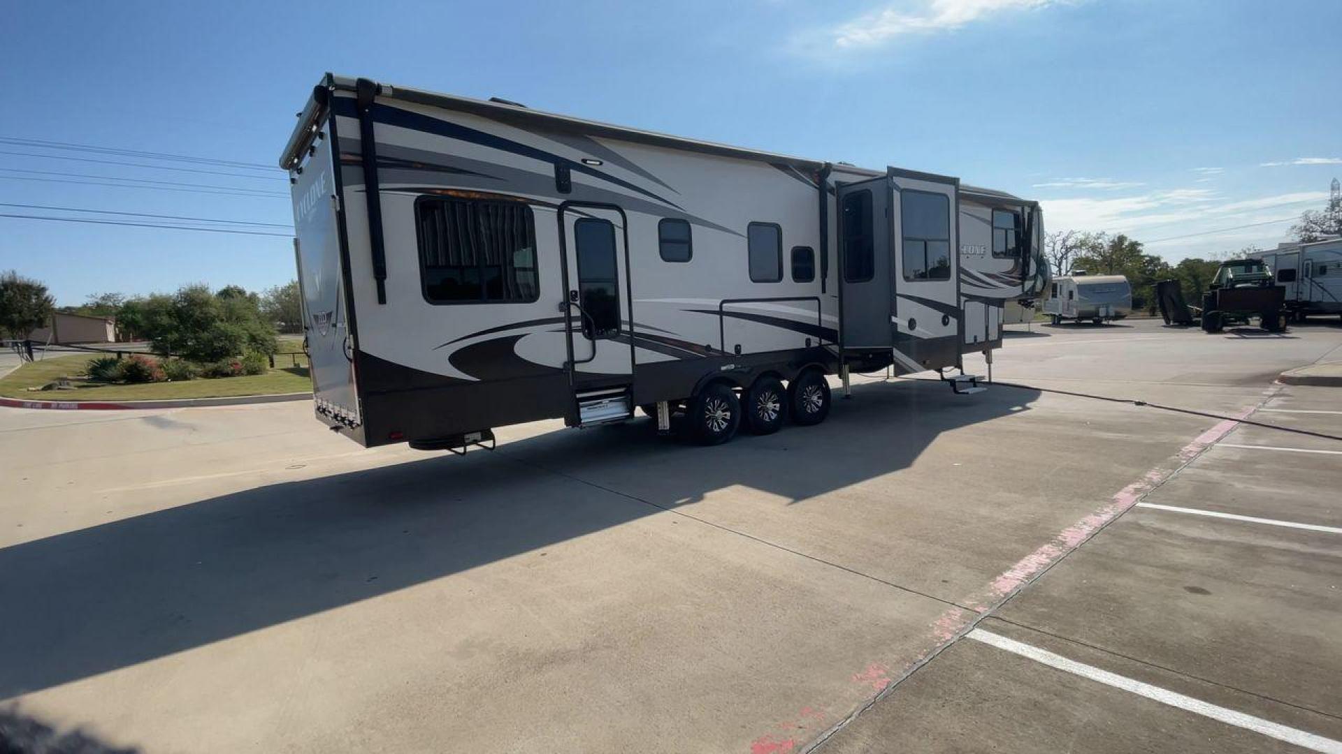 2017 HEARTLAND CYCLONE 4005 (5SFCG4434HE) , Length: 44.1 ft. | Dry Weight: 16,290 lbs.| Gross Weight: 20,000 lbs. | Slides: 3 transmission, located at 4319 N Main Street, Cleburne, TX, 76033, (817) 221-0660, 32.435829, -97.384178 - The 2017 Heartland Cyclone 4005 is a luxury fifth-wheel toy hauler that combines comfort and functionality for adventurers who want the flexibility to bring toys along for the ride. Known for its spacious garage, upscale living area, and ample sleeping options, this model is ideal for thrill-seekers - Photo#1