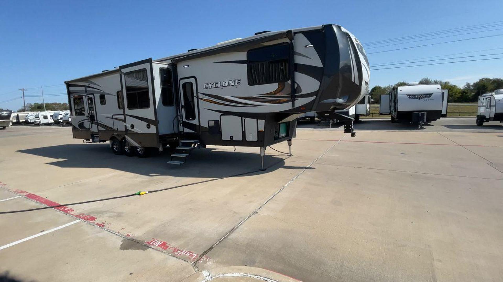 2017 HEARTLAND CYCLONE 4005 (5SFCG4434HE) , Length: 44.1 ft. | Dry Weight: 16,290 lbs.| Gross Weight: 20,000 lbs. | Slides: 3 transmission, located at 4319 N Main Street, Cleburne, TX, 76033, (817) 221-0660, 32.435829, -97.384178 - The 2017 Heartland Cyclone 4005 is a luxury fifth-wheel toy hauler that combines comfort and functionality for adventurers who want the flexibility to bring toys along for the ride. Known for its spacious garage, upscale living area, and ample sleeping options, this model is ideal for thrill-seekers - Photo#3