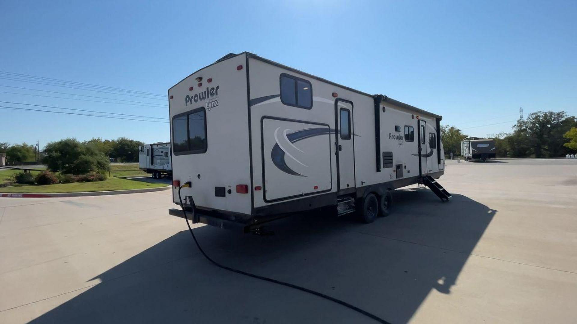 2017 HEARTLAND PROWLER 32LX (5SFPB3622JE) , Length: 36.4 ft. | Dry Weight: 7,880 lbs | Gross Weight: 9,000 lbs | Slides: 2 transmission, located at 4319 N Main Street, Cleburne, TX, 76033, (817) 221-0660, 32.435829, -97.384178 - The 2017 Heartland Prowler 32LX travel trailer has dimensions of 36.4 ft in length, 8 ft width, 11.2 ft height, and 6.8 ft interior height. It has a base weight of 7,880 lbs with a 9,000 lbs GVWR and a carrying capacity of 1,120 lbs. This unit highlights an outdoor kitchen, a rear bunkhouse, a p - Photo#1