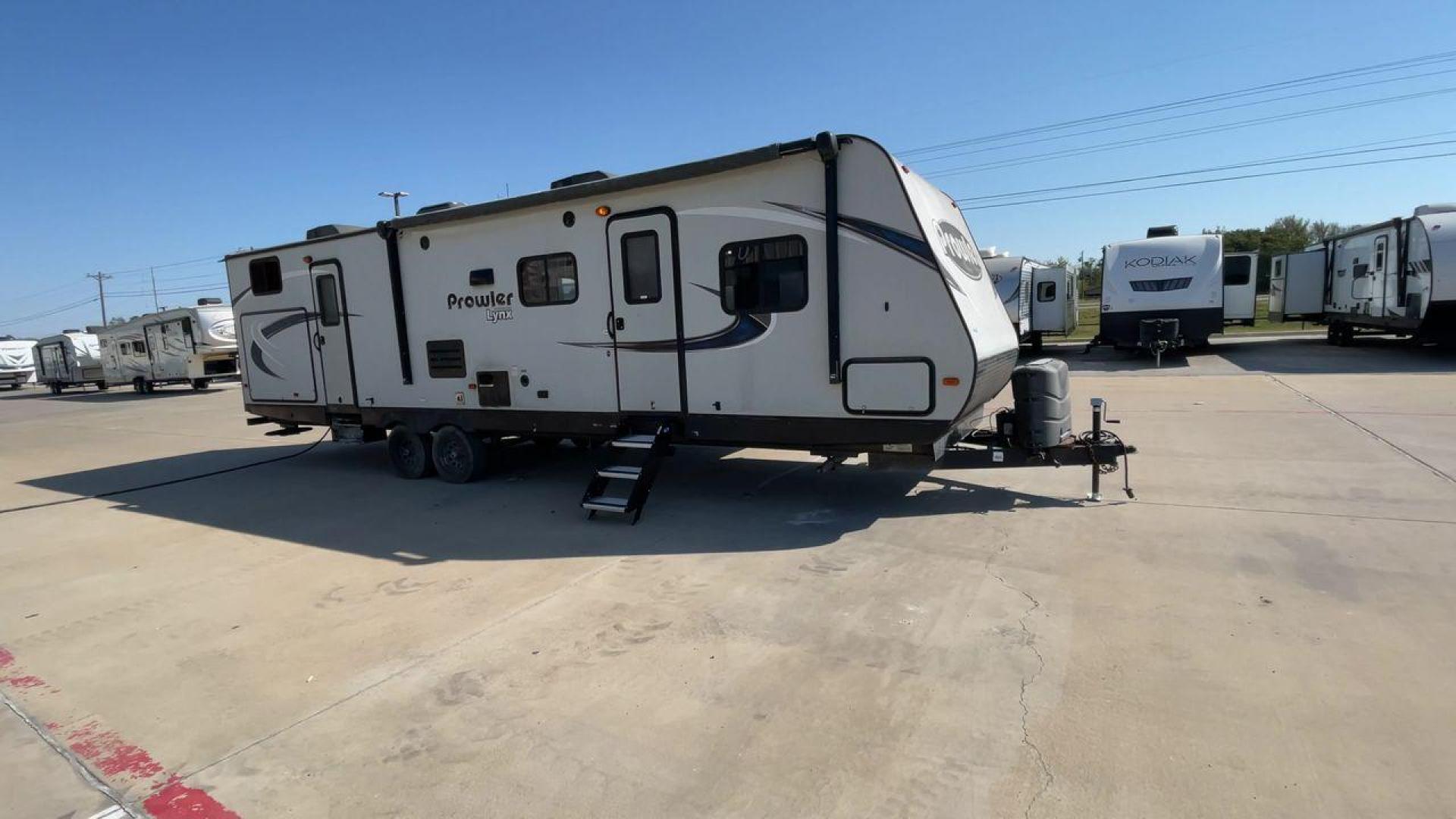 2017 HEARTLAND PROWLER 32LX (5SFPB3622JE) , Length: 36.4 ft. | Dry Weight: 7,880 lbs | Gross Weight: 9,000 lbs | Slides: 2 transmission, located at 4319 N Main Street, Cleburne, TX, 76033, (817) 221-0660, 32.435829, -97.384178 - The 2017 Heartland Prowler 32LX travel trailer has dimensions of 36.4 ft in length, 8 ft width, 11.2 ft height, and 6.8 ft interior height. It has a base weight of 7,880 lbs with a 9,000 lbs GVWR and a carrying capacity of 1,120 lbs. This unit highlights an outdoor kitchen, a rear bunkhouse, a p - Photo#3