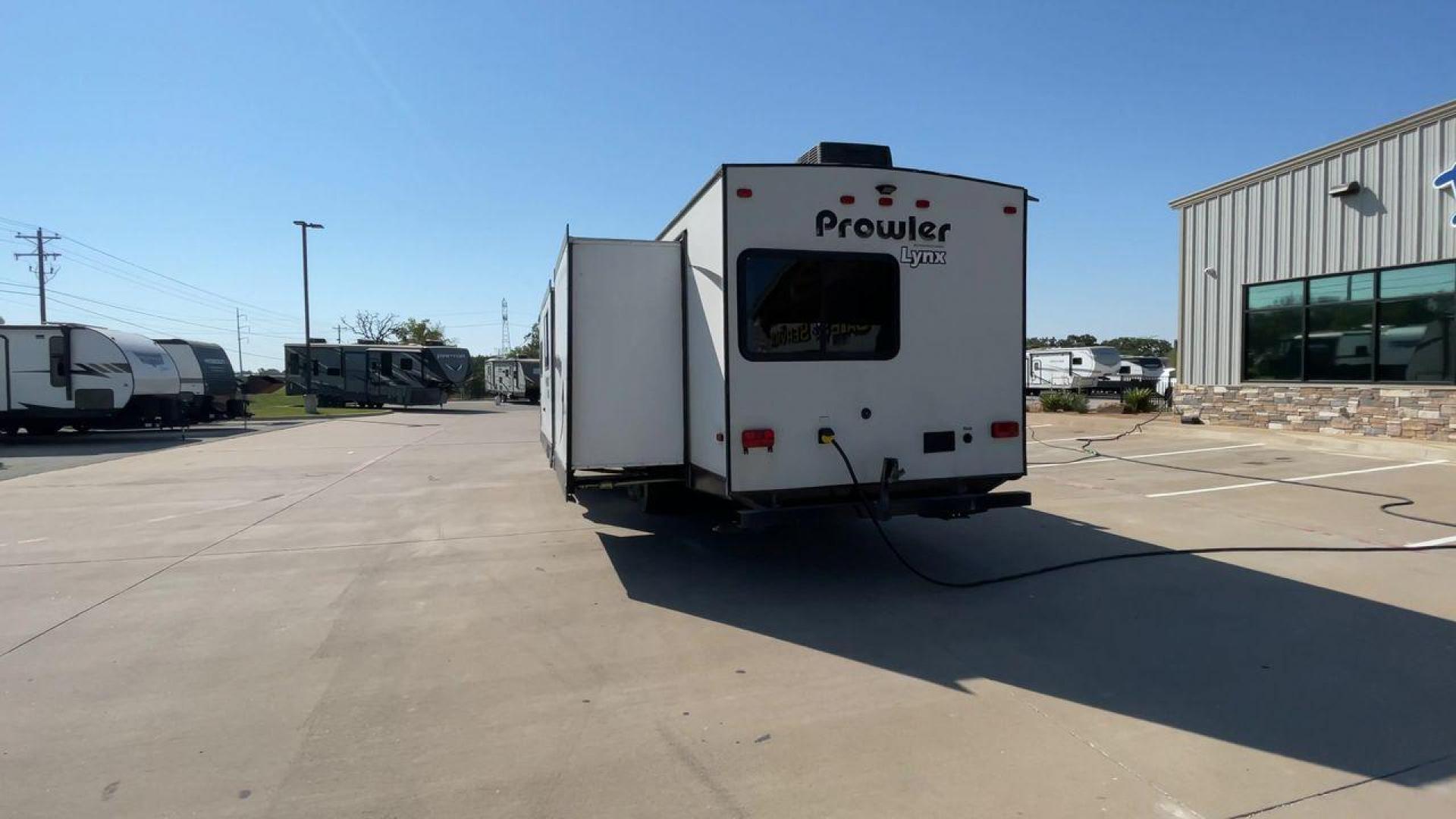 2017 HEARTLAND PROWLER 32LX (5SFPB3622JE) , Length: 36.4 ft. | Dry Weight: 7,880 lbs | Gross Weight: 9,000 lbs | Slides: 2 transmission, located at 4319 N Main Street, Cleburne, TX, 76033, (817) 221-0660, 32.435829, -97.384178 - The 2017 Heartland Prowler 32LX travel trailer has dimensions of 36.4 ft in length, 8 ft width, 11.2 ft height, and 6.8 ft interior height. It has a base weight of 7,880 lbs with a 9,000 lbs GVWR and a carrying capacity of 1,120 lbs. This unit highlights an outdoor kitchen, a rear bunkhouse, a p - Photo#8