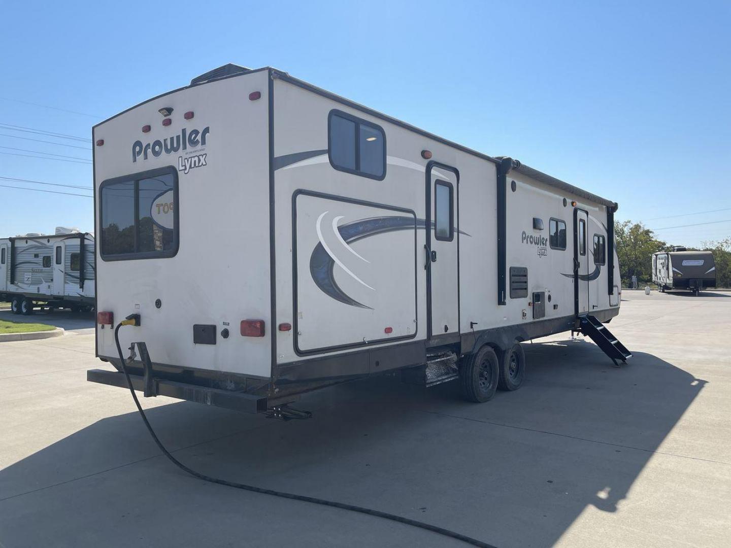 2017 HEARTLAND PROWLER 32LX (5SFPB3622JE) , Length: 36.4 ft. | Dry Weight: 7,880 lbs | Gross Weight: 9,000 lbs | Slides: 2 transmission, located at 4319 N Main Street, Cleburne, TX, 76033, (817) 221-0660, 32.435829, -97.384178 - The 2017 Heartland Prowler 32LX travel trailer has dimensions of 36.4 ft in length, 8 ft width, 11.2 ft height, and 6.8 ft interior height. It has a base weight of 7,880 lbs with a 9,000 lbs GVWR and a carrying capacity of 1,120 lbs. This unit highlights an outdoor kitchen, a rear bunkhouse, a p - Photo#25