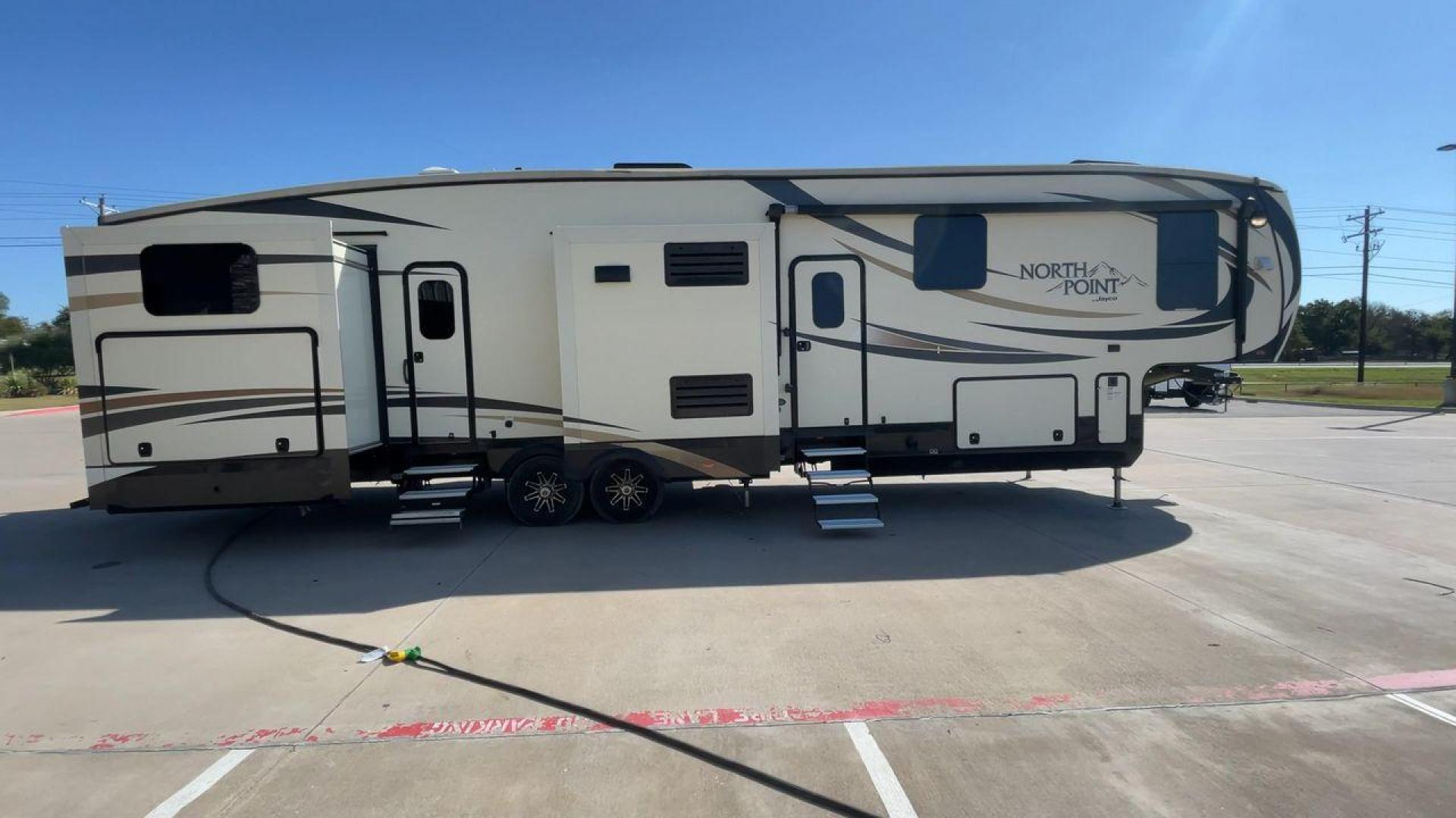 2017 TAN JAYCO NORTH POINT 375BHFS (1UJCJ0BV2H1) , Length: 43.25 ft.| Dry Weight: 13,740 lbs. | Gross Weight: 16,500 lbs. | Slides: 5 transmission, located at 4319 N Main Street, Cleburne, TX, 76033, (817) 221-0660, 32.435829, -97.384178 - Five slides, one-and-a-half baths, a bunkhouse, and an outdoor kitchen are just some of the highlights of this North Point fifth wheel model 375BHFS by Jayco. This fifth wheel measures 43.25 ft in length, 8 ft in width, 13.33 ft in height, and 6.83 ft in interior height. It has a dry weight of 1 - Photo#2