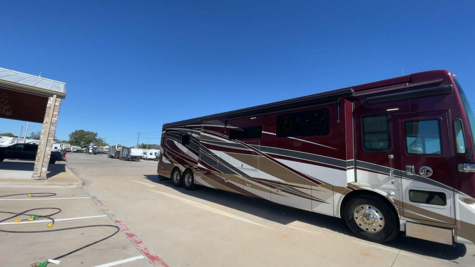 2017 TIFFIN ALLEGRO BUS 45OPP (5VBBAK7A6HA) , Length: 45 ft | Gross Weight: 51,000 lbs | Slides: 4 transmission, located at 4319 N Main Street, Cleburne, TX, 76033, (817) 221-0660, 32.435829, -97.384178 - The 2017 TIFFIN ALLEGRO BUS 45OPP features a luxurious exterior with a striking maroon, white, and beige paint scheme. The large, sleek side panels are accentuated by elegant, sweeping graphics, giving it an upscale, eye-catching look. The motorhome is built on a spacious chassis, with a prominent f - Photo#3