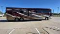 2017 TIFFIN ALLEGRO BUS 45OPP (5VBBAK7A6HA) , Length: 45 ft | Gross Weight: 51,000 lbs | Slides: 4 transmission, located at 4319 N Main Street, Cleburne, TX, 76033, (817) 221-0660, 32.435829, -97.384178 - The 2017 TIFFIN ALLEGRO BUS 45OPP features a luxurious exterior with a striking maroon, white, and beige paint scheme. The large, sleek side panels are accentuated by elegant, sweeping graphics, giving it an upscale, eye-catching look. The motorhome is built on a spacious chassis, with a prominent f - Photo#2