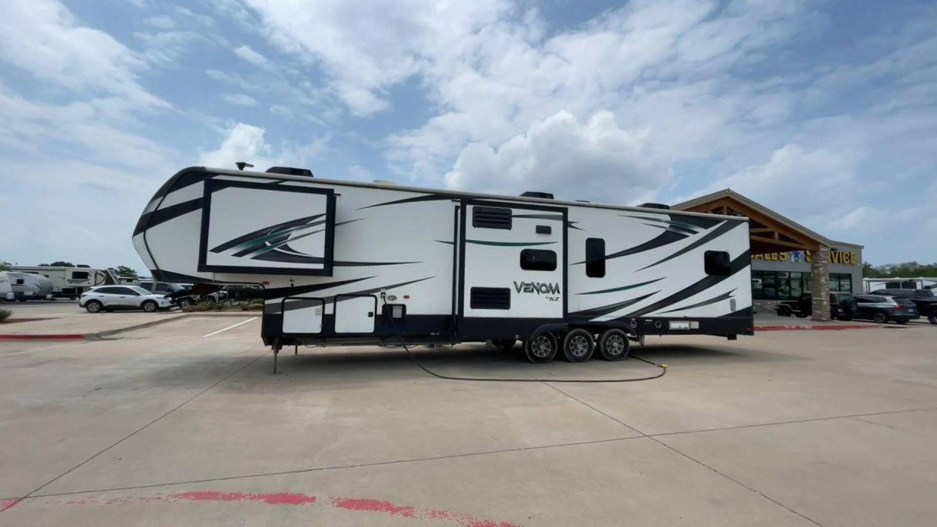 2017 BLACK VENOM 4013TK - (4EZFH4039H6) , Length: 43.33 ft. | Dry Weight: 14,760 lbs. | Gross Weight: 19,000 lbs. | Slides: 3 transmission, located at 4319 N Main Street, Cleburne, TX, 76033, (817) 221-0660, 32.435829, -97.384178 - With the 2017 Venom 4013TK, you can enjoy the highest level of luxury and usefulness. This impressive fifth wheel is 43.33 feet long, so it has plenty of room for your living space and storage for all your camping stuff. It is the right mix of strength and ease of towing, with a dry weight of 14,760 - Photo#0