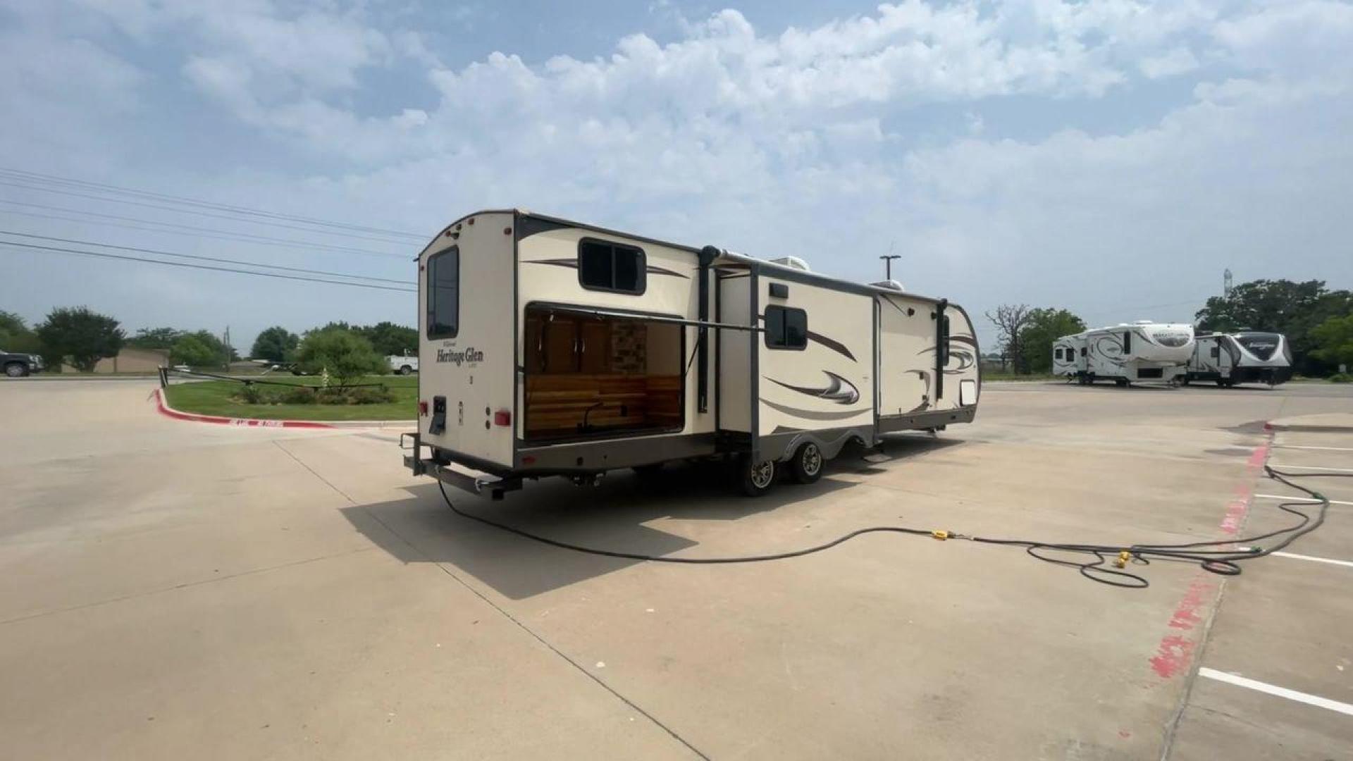 2017 TAN WILDWOOD HERITAGE GLEN 300BH (4X4TWBF29HU) , Length: 37.42 ft. | Dry Weight: 8,439 lbs. | Slides: 3 transmission, located at 4319 N Main Street, Cleburne, TX, 76033, (817) 221-0660, 32.435829, -97.384178 - The 2017 Wildwood Heritage Glen 300BH has roomy and comfortable rooms for your outdoor activities. This travel trailer offers ample space for the entire family, measuring 37.42 feet in length and weighing 8,439 pounds when dry. This trailer is designed with three slides, providing ample interior spa - Photo#1