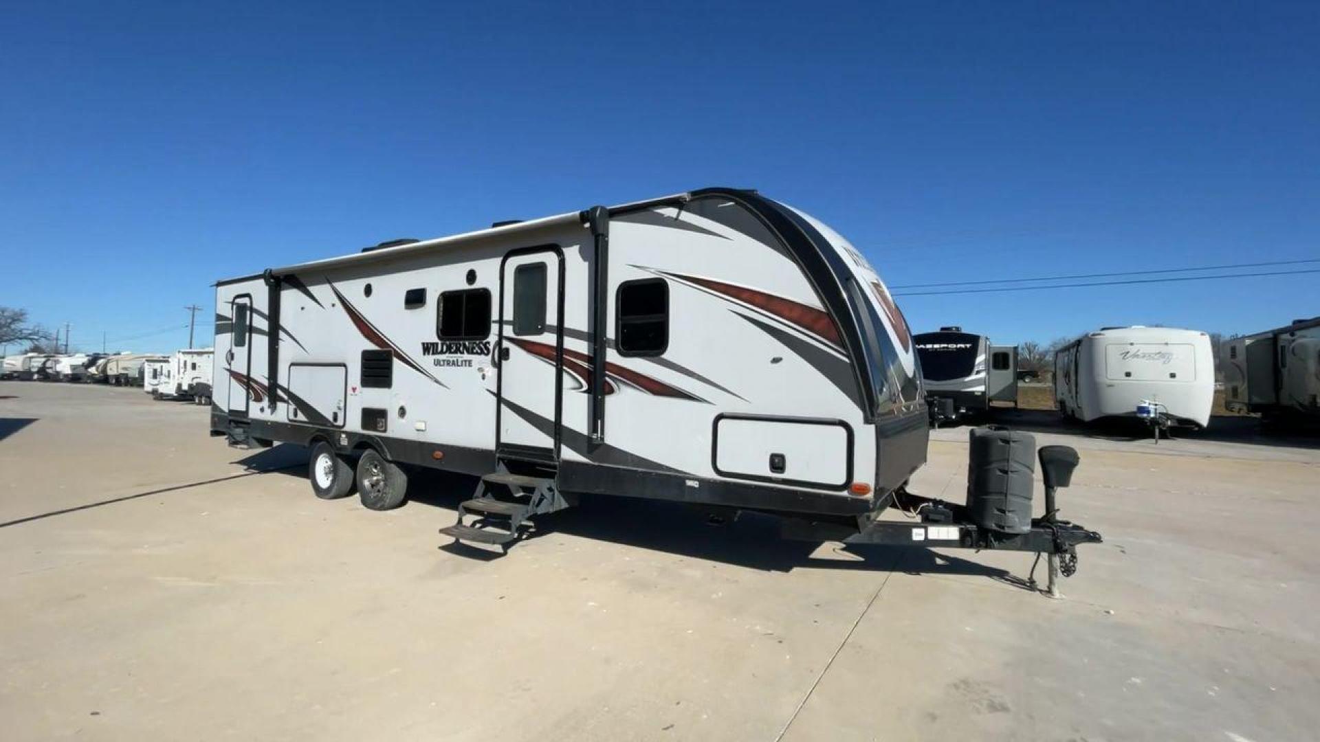 2018 GRAY HEARTLAND WILDERNESS USED 3125 (5SFNB3526JE) , Length: 35.75 ft. | Dry Weight: 6,840 lbs. | Gross Weight: 8,600 lbs. | Slides: 1 transmission, located at 4319 N Main Street, Cleburne, TX, 76033, (817) 221-0660, 32.435829, -97.384178 - Discover your inner adventurer with the Heartland Wilderness 3125 travel trailer from 2018. This RV offers the ideal balance of roomy living, contemporary conveniences, and tough sturdiness for your outdoor adventures. It is designed for individuals who desire both comfort and exploration. The dimen - Photo#2