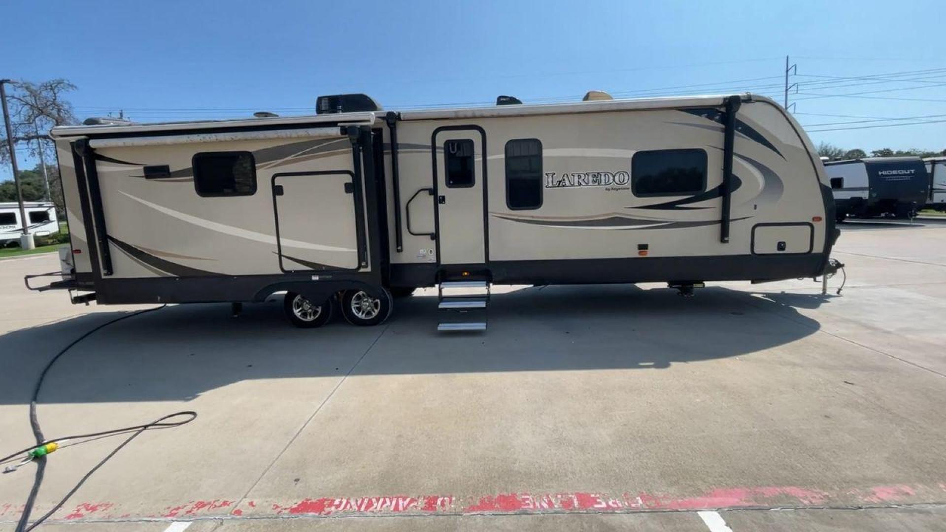 2018 KEYSTONE LAREDO 335MK (4YDT33524JV) , Length: 37.92 ft. | Dry Weight: 8,473 lbs. | Gross Weight: 10,000 lbs. | Slides: 2 transmission, located at 4319 N Main Street, Cleburne, TX, 76033, (817) 221-0660, 32.435829, -97.384178 - The 2018 Keystone Laredo 335MK is a spacious and feature-packed travel trailer with a length of 37.92 ft, a dry weight of 8,473 lbs, and a gross weight capacity of 10,000 lbs. It includes two large slide-outs, significantly expanding the living and kitchen areas. The exterior features a cream and be - Photo#2