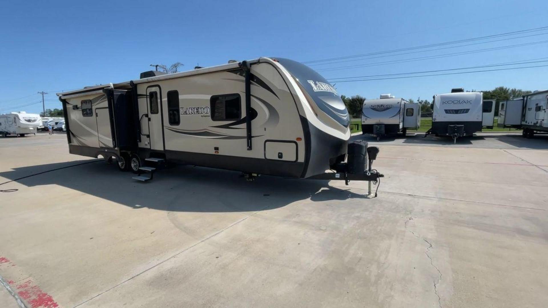 2018 KEYSTONE LAREDO 335MK (4YDT33524JV) , Length: 37.92 ft. | Dry Weight: 8,473 lbs. | Gross Weight: 10,000 lbs. | Slides: 2 transmission, located at 4319 N Main Street, Cleburne, TX, 76033, (817) 221-0660, 32.435829, -97.384178 - The 2018 Keystone Laredo 335MK is a spacious and feature-packed travel trailer with a length of 37.92 ft, a dry weight of 8,473 lbs, and a gross weight capacity of 10,000 lbs. It includes two large slide-outs, significantly expanding the living and kitchen areas. The exterior features a cream and be - Photo#3