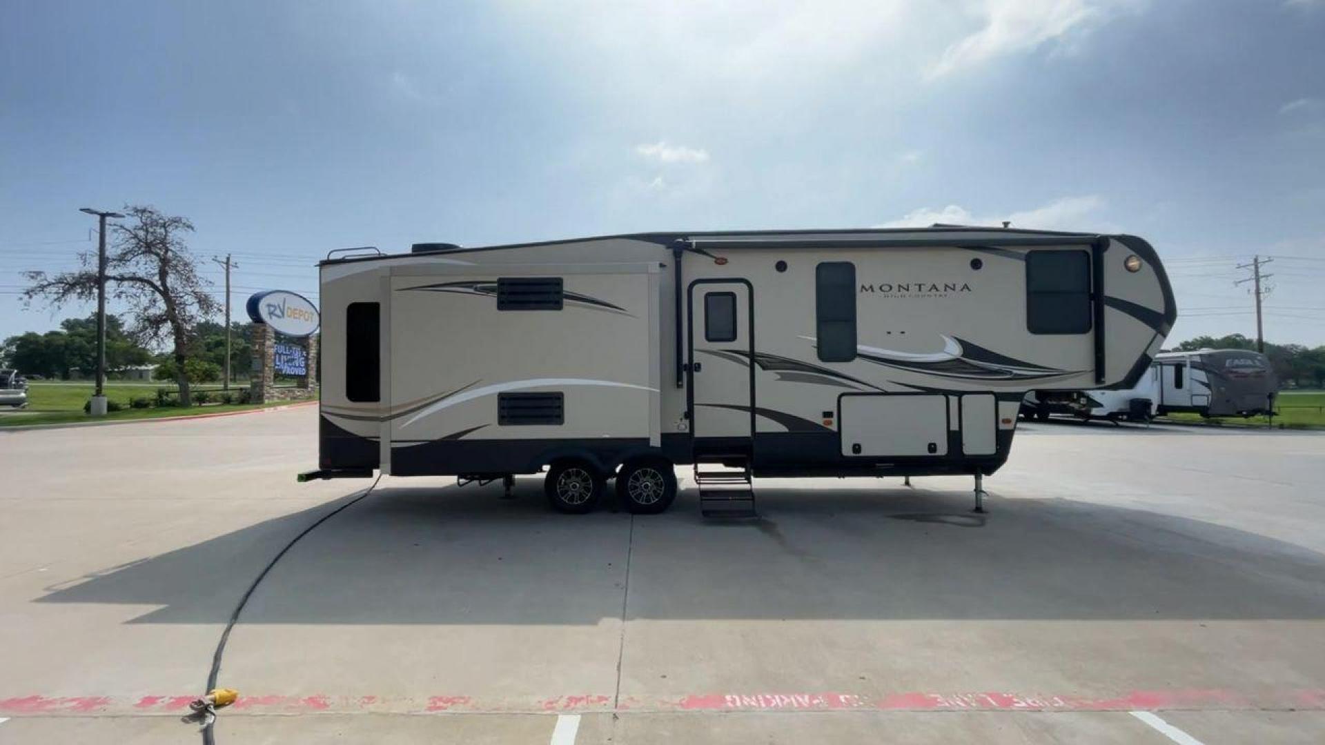 2018 TAN KEYSTONE MONTANA 305RL (4YDF3052XJA) , Length: 35.67 ft. | Dry Weight: 10,390 lbs. | Gross Weight: 14,270 lbs. | Slides: 3 transmission, located at 4319 N Main Street, Cleburne, TX, 76033, (817) 221-0660, 32.435829, -97.384178 - The 2018 Keystone Montana 305RL is a dual-axle aluminum wheel set-up that measures 35.67 ft. in length. It has a dry weight of 10,390 lbs. and a GVWR of 14,270 lbs. It is made of aluminum and fiberglass. It comes with automatic heating and cooling rated at 35,000 and 15,000 BTUs respectively. With 3 - Photo#2