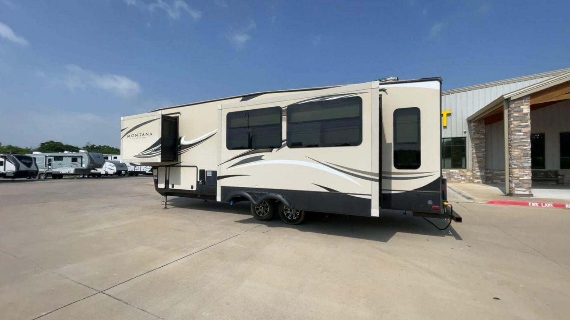 2018 TAN KEYSTONE MONTANA 305RL (4YDF3052XJA) , Length: 35.67 ft. | Dry Weight: 10,390 lbs. | Gross Weight: 14,270 lbs. | Slides: 3 transmission, located at 4319 N Main Street, Cleburne, TX, 76033, (817) 221-0660, 32.435829, -97.384178 - The 2018 Keystone Montana 305RL is a dual-axle aluminum wheel set-up that measures 35.67 ft. in length. It has a dry weight of 10,390 lbs. and a GVWR of 14,270 lbs. It is made of aluminum and fiberglass. It comes with automatic heating and cooling rated at 35,000 and 15,000 BTUs respectively. With 3 - Photo#7