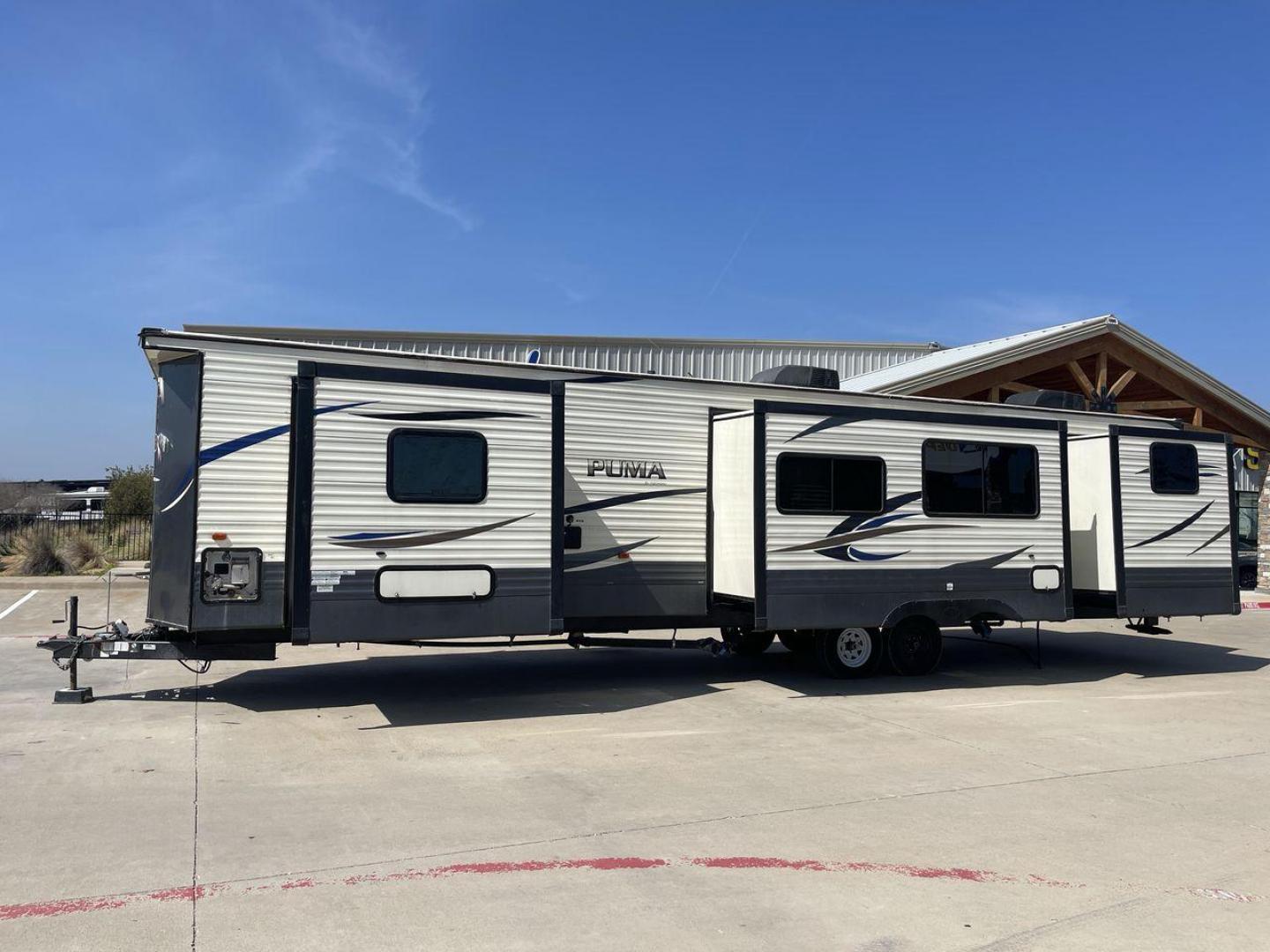 2018 PUMA 39PQB - (4X4TPUR2XJP) , located at 4319 N Main Street, Cleburne, TX, 76033, (817) 221-0660, 32.435829, -97.384178 - This Puma Travel Trailer measures just over 42 feet long and 8 feet wide with a dry weight of 10,709 lbs. It has a GVWR of 13,413 lbs and a hitch weight of 1,413 lbs. This unit comes with automatic heating and cooling rated at 35,000 and 13,500 BTUs respectively. The exterior of this unit is a base - Photo#24