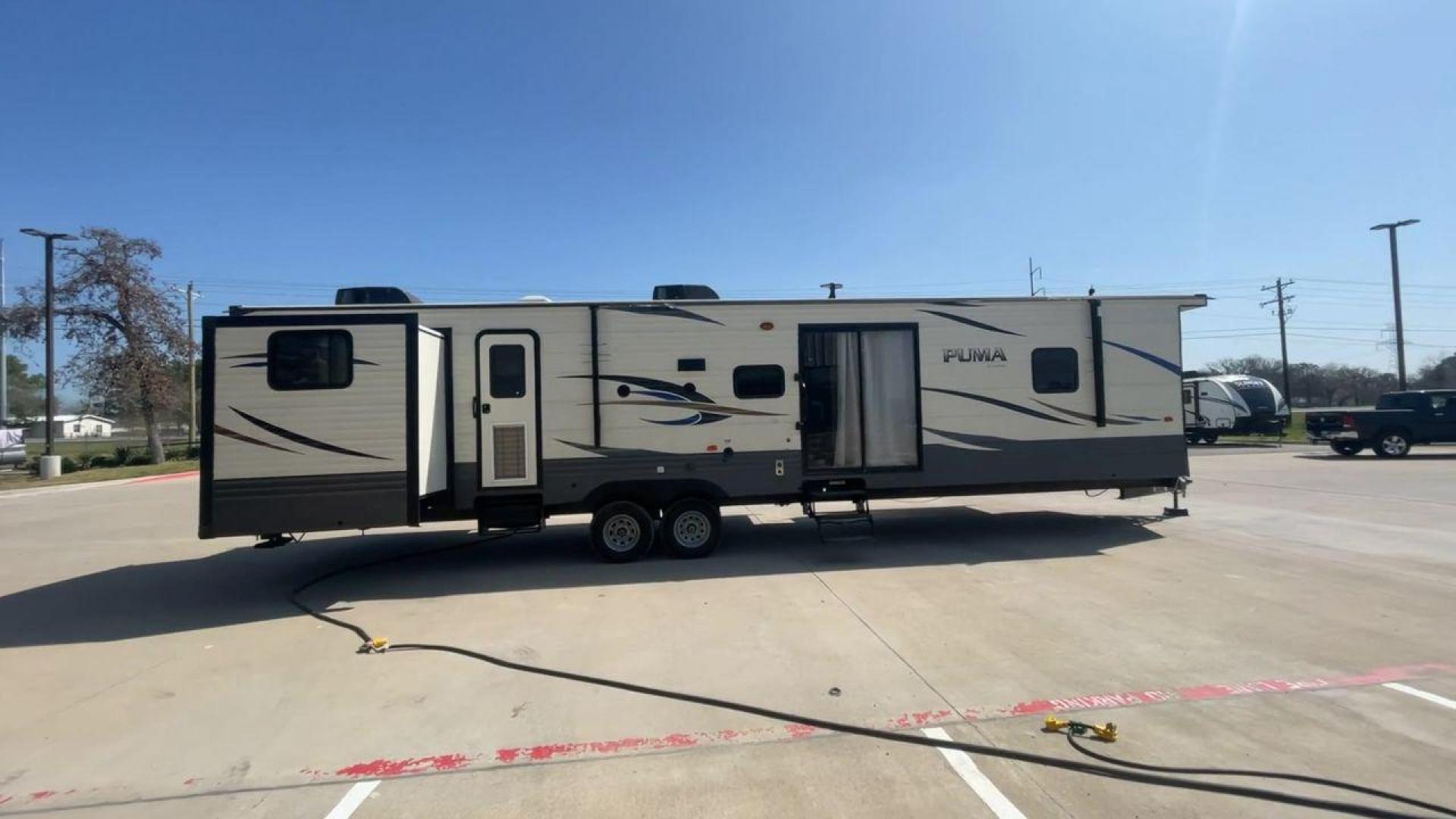 2018 PUMA 39PQB - (4X4TPUR2XJP) , located at 4319 N Main Street, Cleburne, TX, 76033, (817) 221-0660, 32.435829, -97.384178 - This Puma Travel Trailer measures just over 42 feet long and 8 feet wide with a dry weight of 10,709 lbs. It has a GVWR of 13,413 lbs and a hitch weight of 1,413 lbs. This unit comes with automatic heating and cooling rated at 35,000 and 13,500 BTUs respectively. The exterior of this unit is a base - Photo#2