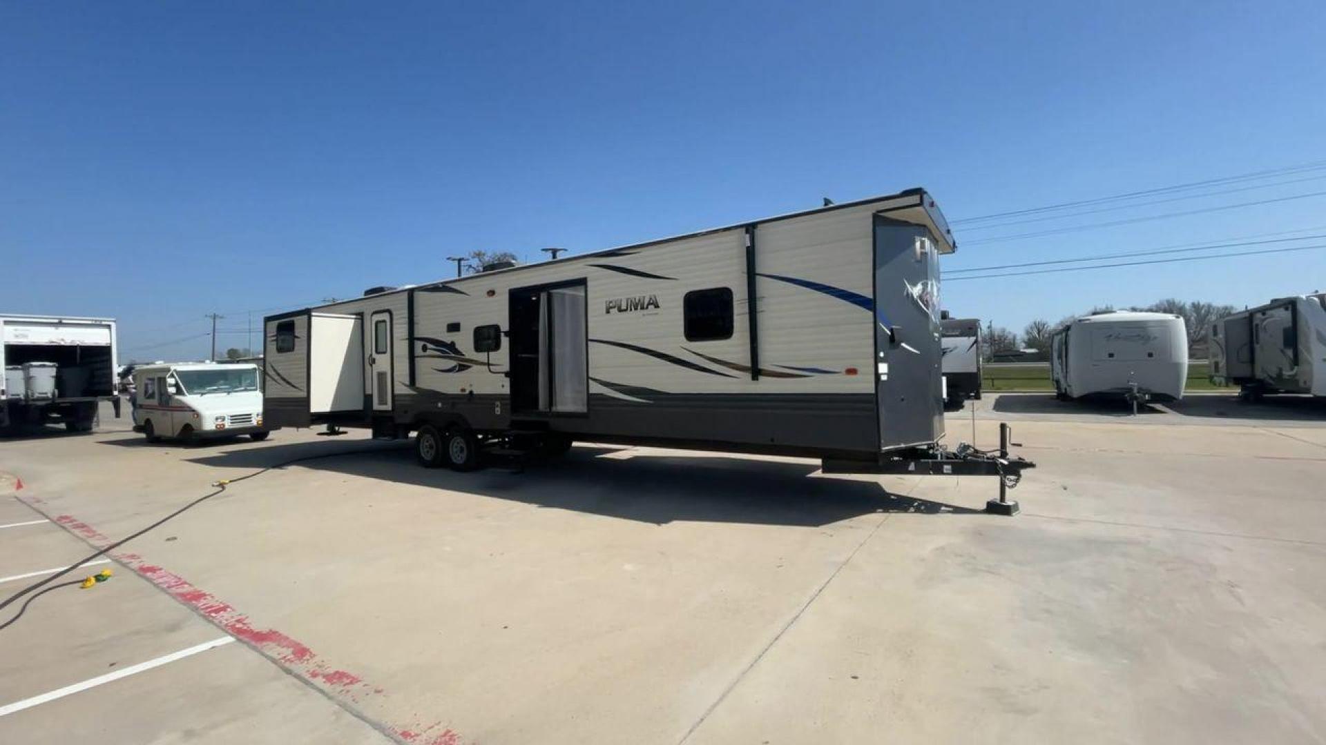 2018 PUMA 39PQB - (4X4TPUR2XJP) , located at 4319 N Main Street, Cleburne, TX, 76033, (817) 221-0660, 32.435829, -97.384178 - This Puma Travel Trailer measures just over 42 feet long and 8 feet wide with a dry weight of 10,709 lbs. It has a GVWR of 13,413 lbs and a hitch weight of 1,413 lbs. This unit comes with automatic heating and cooling rated at 35,000 and 13,500 BTUs respectively. The exterior of this unit is a base - Photo#3