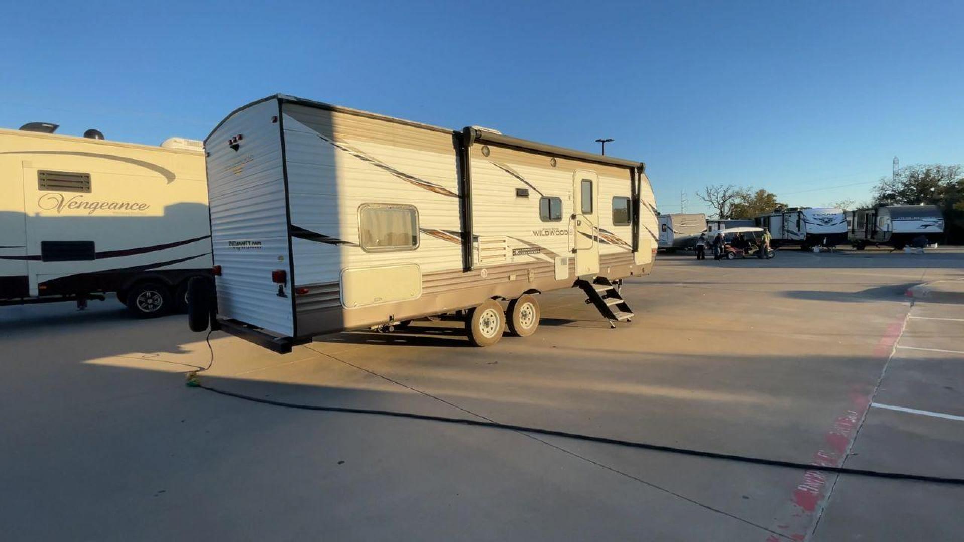 2018 TAN WILDWOOD 28DBUD (4X4TWDD29JA) , Length: 29.5 ft. | Dry Weight: 6,223 lbs. | Slides: 1 transmission, located at 4319 N Main Street, Cleburne, TX, 76033, (817) 221-0660, 32.435829, -97.384178 - The 2018 Wildwood 28DBUD measures just a bit under 30 ft. in length. It has a dry weight of 6,223 lbs. and a payload capacity of 1,549 lbs. It is a dual-axle steel wheel with one power-retractable slide. Inside, you will find a spacious main area with linoleum flooring. Immediately to the left of t - Photo#1