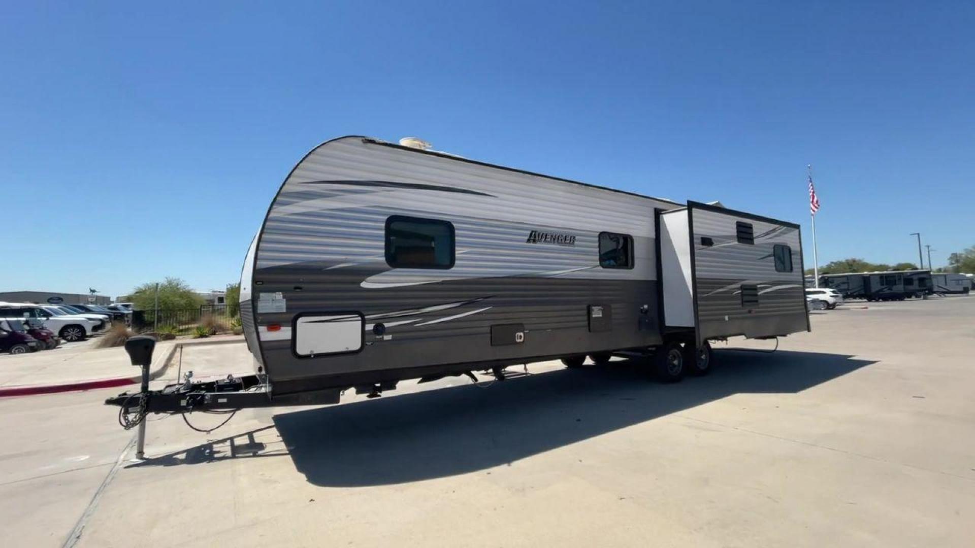 2019 TAN FOREST RIVER AVENGER 32DEN (5ZT2AVXB6KB) , Length: 37.92 ft. | Dry Weight: 7,989 lbs. | Slides: 2 transmission, located at 4319 N Main Street, Cleburne, TX, 76033, (817) 221-0660, 32.435829, -97.384178 - Measuring an impressive 36 feet, this model unfolds to reveal two strategically placed slide-outs, creating a spacious haven for relaxation. The master bedroom welcomes you with a queen-size bed and ample storage, ensuring a peaceful retreat after a day of outdoor exploration. The living area is a h - Photo#5