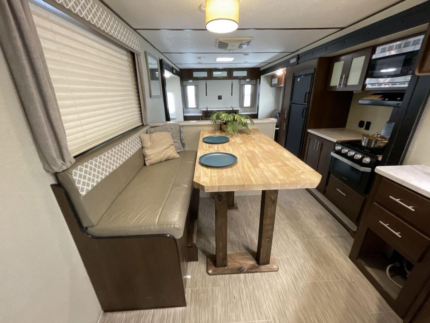 2019 TAN FOREST RIVER AVENGER 32DEN (5ZT2AVXB6KB) , Length: 37.92 ft. | Dry Weight: 7,989 lbs. | Slides: 2 transmission, located at 4319 N Main Street, Cleburne, TX, 76033, (817) 221-0660, 32.435829, -97.384178 - Measuring an impressive 36 feet, this model unfolds to reveal two strategically placed slide-outs, creating a spacious haven for relaxation. The master bedroom welcomes you with a queen-size bed and ample storage, ensuring a peaceful retreat after a day of outdoor exploration. The living area is a h - Photo#13