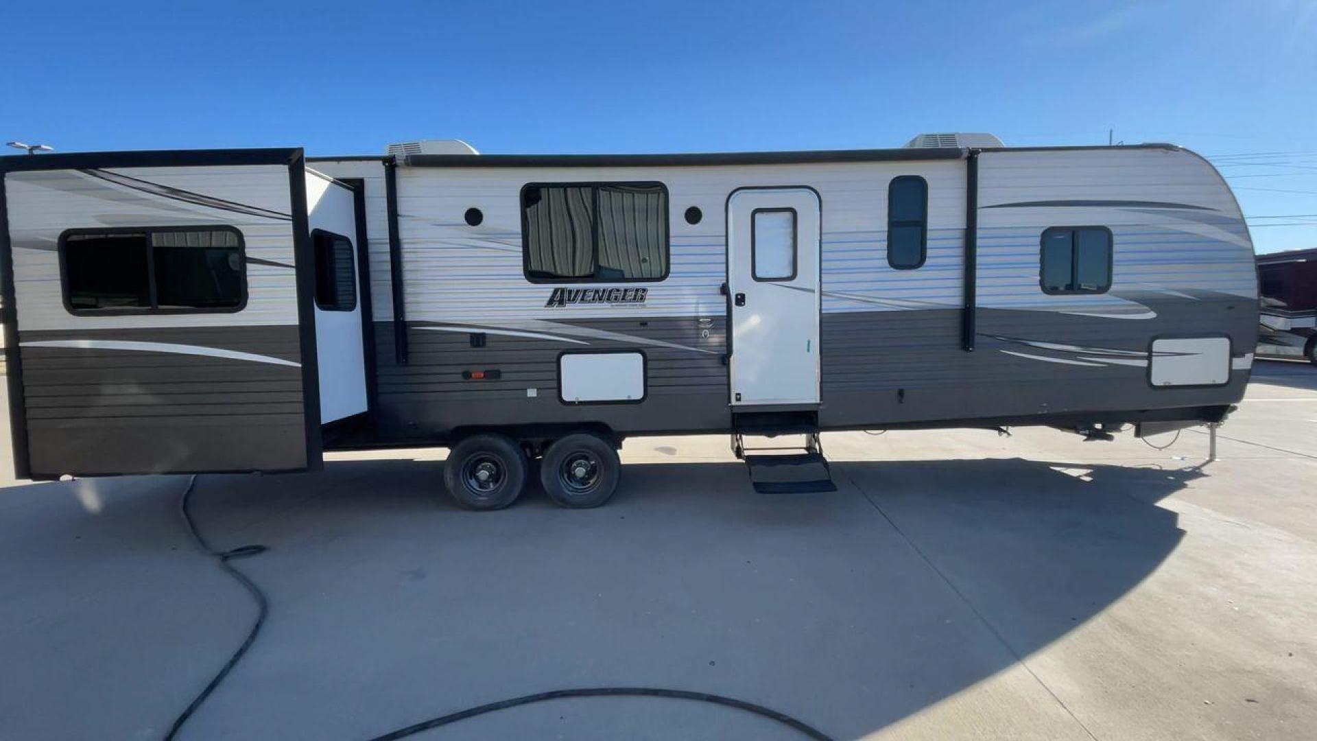 2019 TAN FOREST RIVER AVENGER 32DEN (5ZT2AVXB6KB) , Length: 37.92 ft. | Dry Weight: 7,989 lbs. | Slides: 2 transmission, located at 4319 N Main Street, Cleburne, TX, 76033, (817) 221-0660, 32.435829, -97.384178 - Measuring an impressive 36 feet, this model unfolds to reveal two strategically placed slide-outs, creating a spacious haven for relaxation. The master bedroom welcomes you with a queen-size bed and ample storage, ensuring a peaceful retreat after a day of outdoor exploration. The living area is a h - Photo#2