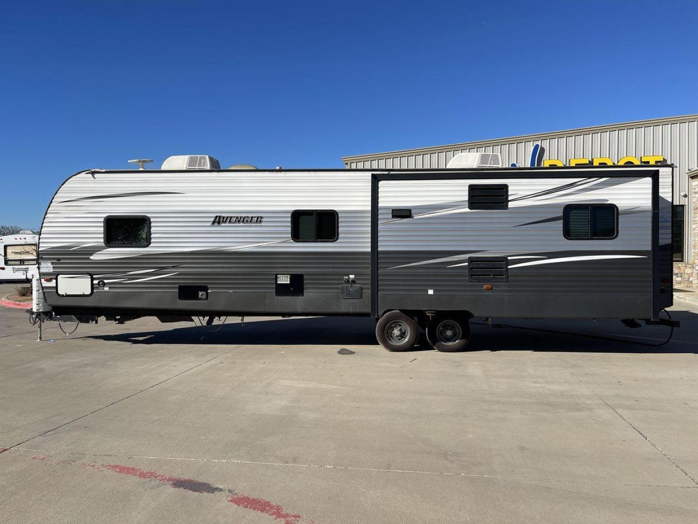 2019 TAN FOREST RIVER AVENGER 32DEN (5ZT2AVXB6KB) , Length: 37.92 ft. | Dry Weight: 7,989 lbs. | Slides: 2 transmission, located at 4319 N Main Street, Cleburne, TX, 76033, (817) 221-0660, 32.435829, -97.384178 - Measuring an impressive 36 feet, this model unfolds to reveal two strategically placed slide-outs, creating a spacious haven for relaxation. The master bedroom welcomes you with a queen-size bed and ample storage, ensuring a peaceful retreat after a day of outdoor exploration. The living area is a h - Photo#24