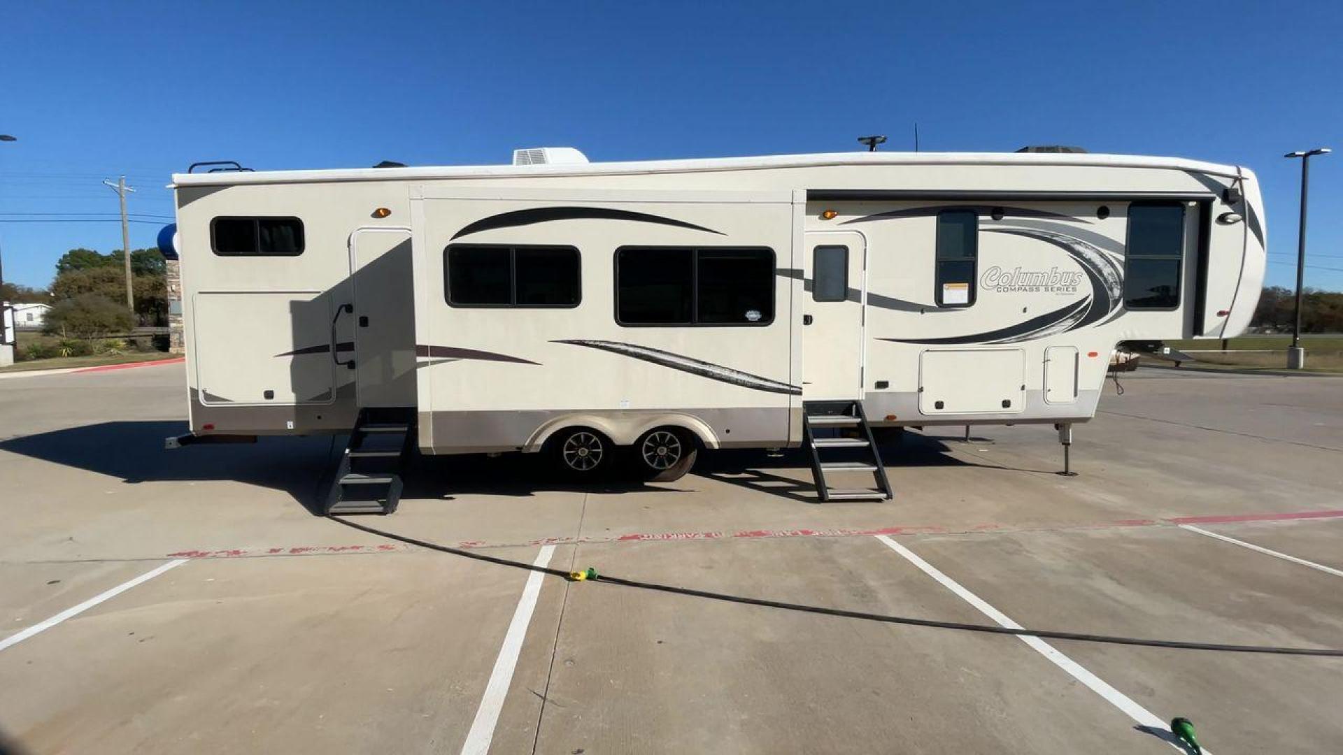 2019 FOREST RIVER COLUMBUS 374BHC (4X4FCMN21K6) , Length: 42.08 ft. | Dry Weight: 12,785 lbs. | Gross Weight: 15,785 lbs. | Slides: 4 transmission, located at 4319 N Main Street, Cleburne, TX, 76033, (817) 221-0660, 32.435829, -97.384178 - The 2019 Forest River Columbus 374BHC is a spacious fifth-wheel travel trailer with a length of 42.08 feet. Its exterior features a smooth beige finish with stylish curved graphics in dark gray and black, giving it a modern and attractive look. The unit has four slides which significantly increases - Photo#2